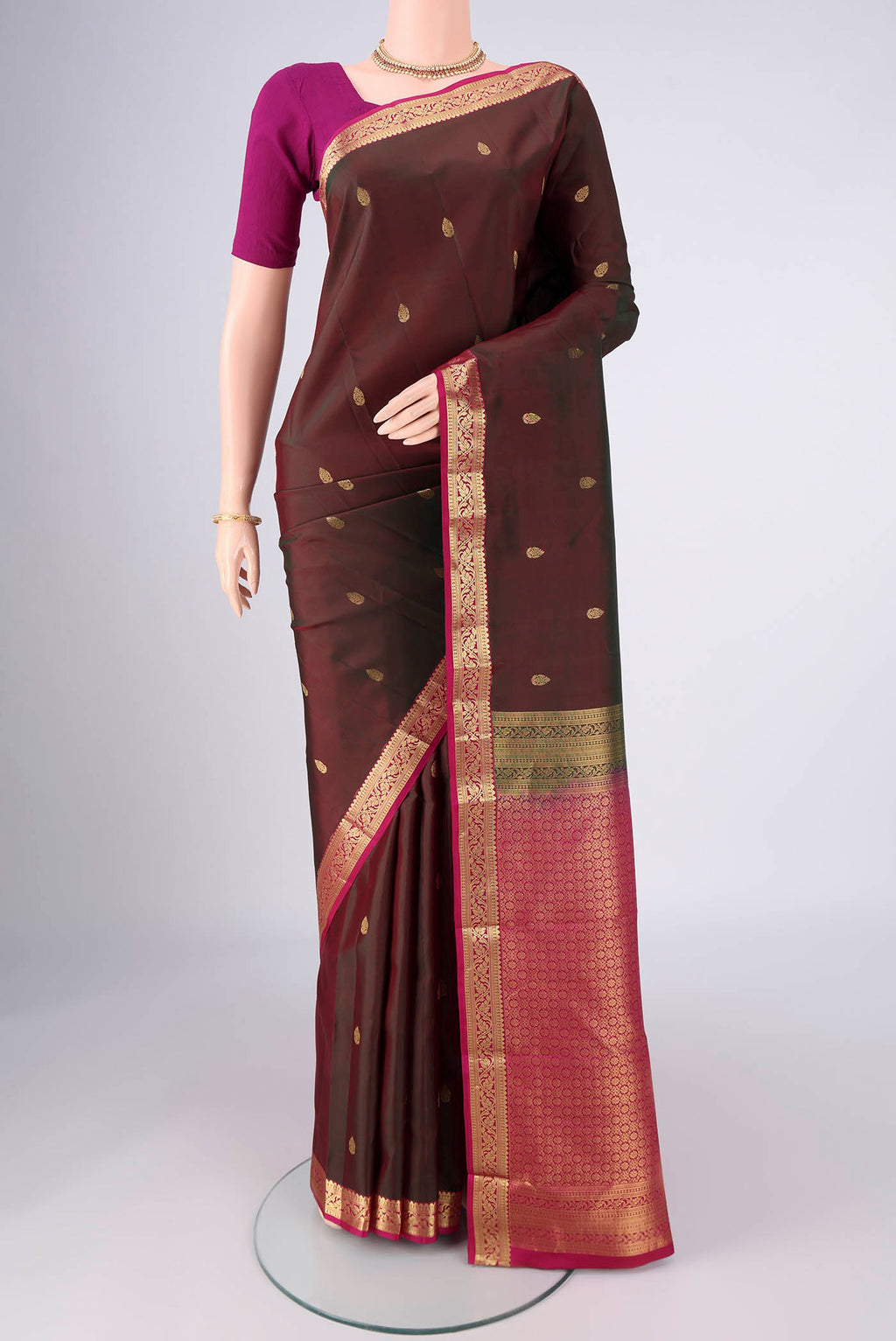 Brown Kanjivaram Silk Saree with Zari Butta on the body and Zari Border.  displayed on a mannequin