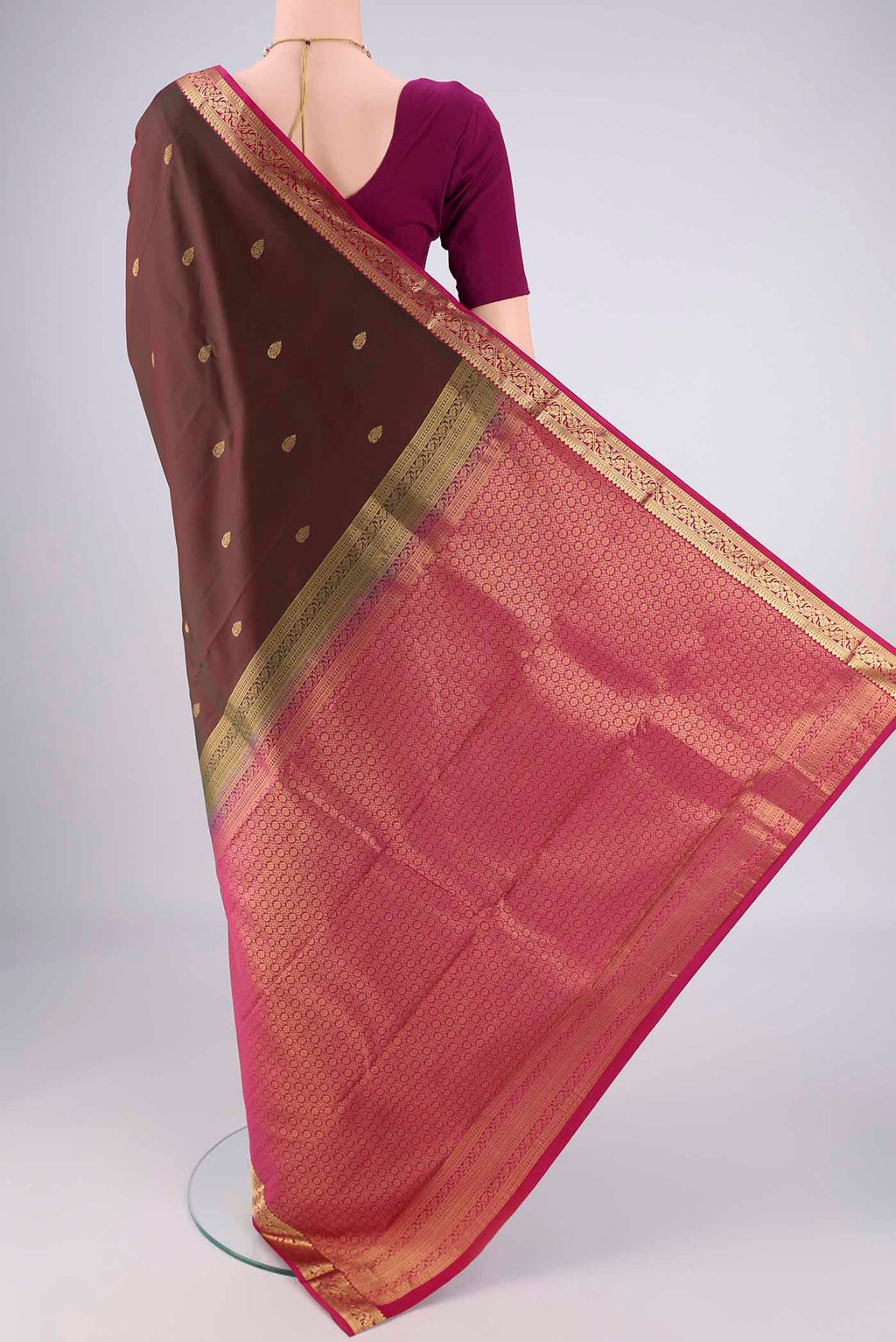 Flat view of Brown Kanjivaram Silk Saree with Zari Butta on the body and Zari Border. 