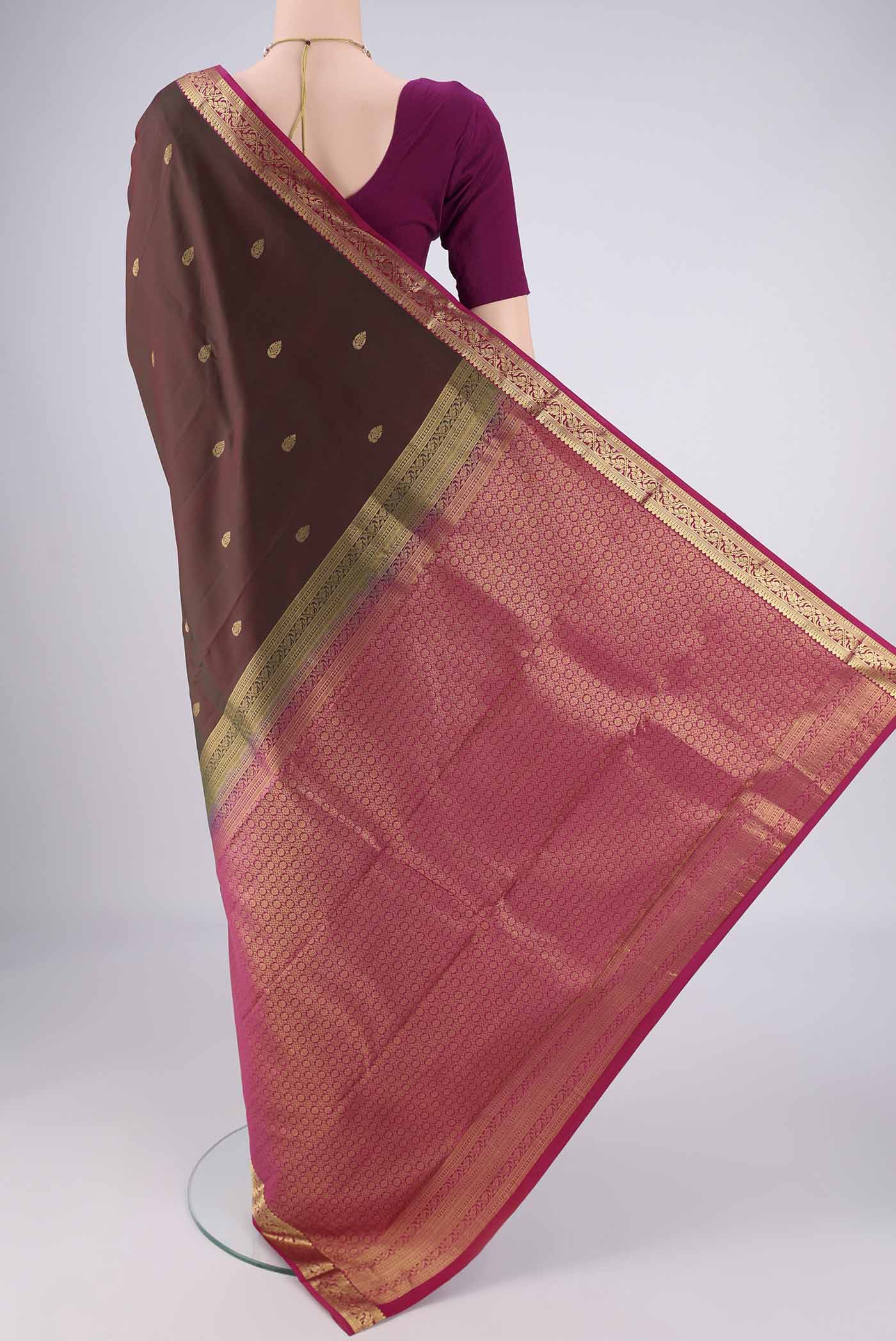 Flat view of Brown Kanjivaram Silk Saree with Zari Butta on the body and Zari Border. 