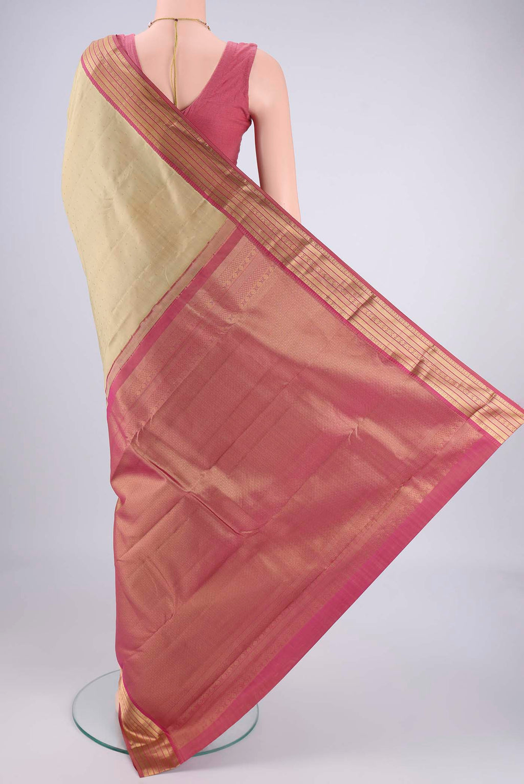 Flat view of Beige Kanchipuram Silk Saree with Zari Butta on the body and Zari Border. 