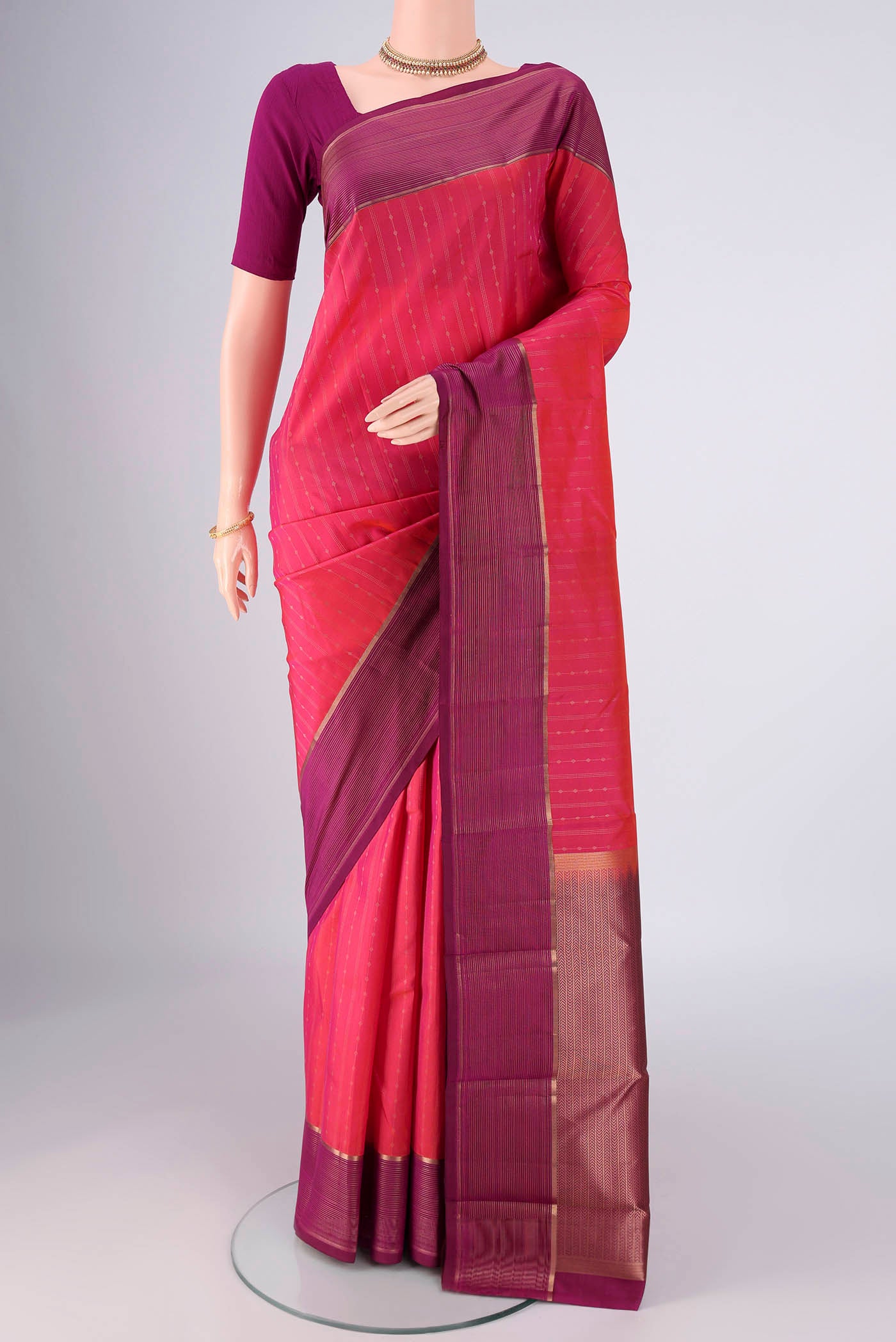 Pink Dual Tone Kanchipuram Silk Saree with Zari Butta on the body and Zari Border.  displayed on a mannequin