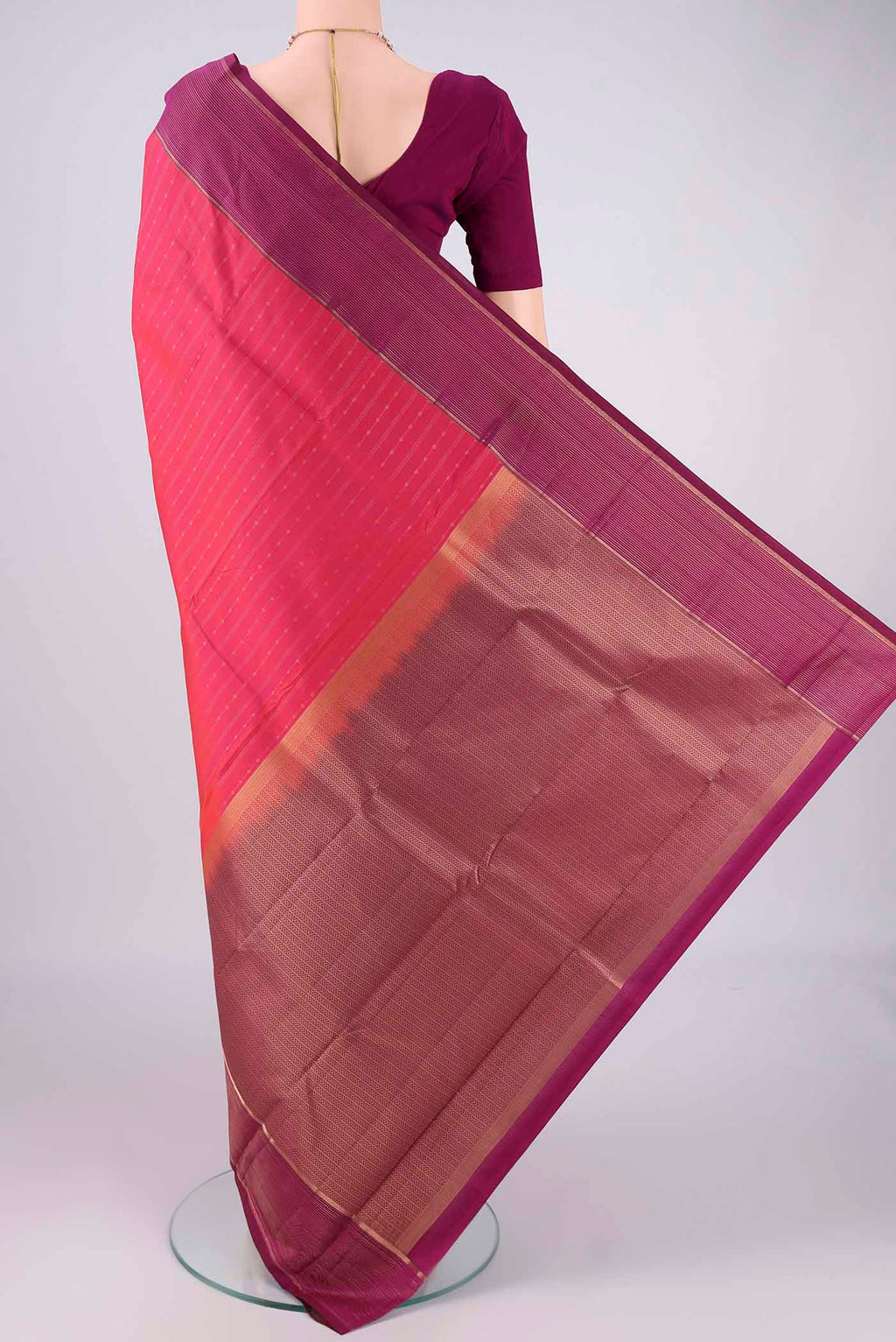 Flat view of Pink Dual Tone Kanchipuram Silk Saree with Zari Butta on the body and Zari Border. 