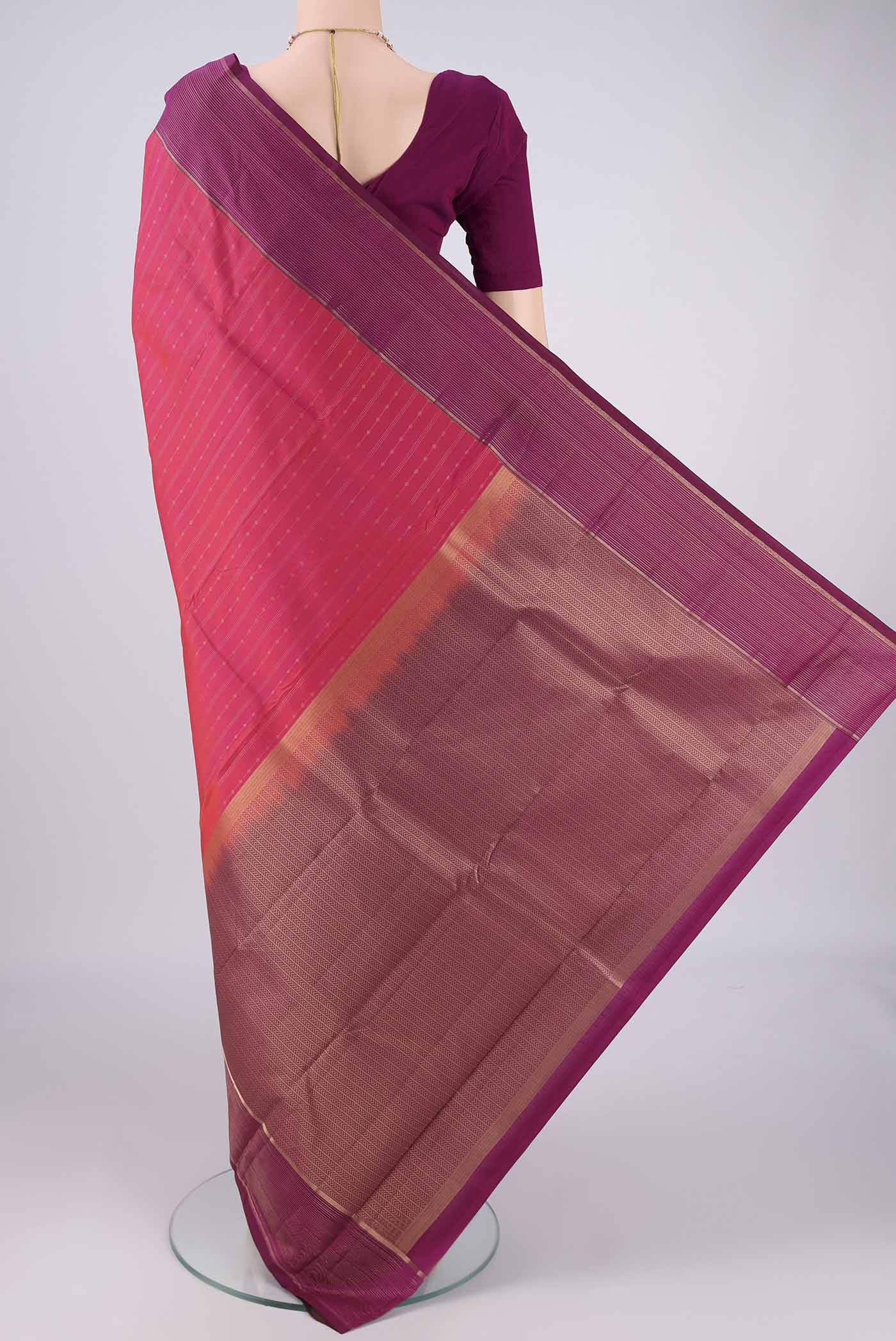 Flat view of Pink Dual Tone Kanchipuram Silk Saree with Zari Butta on the body and Zari Border. 