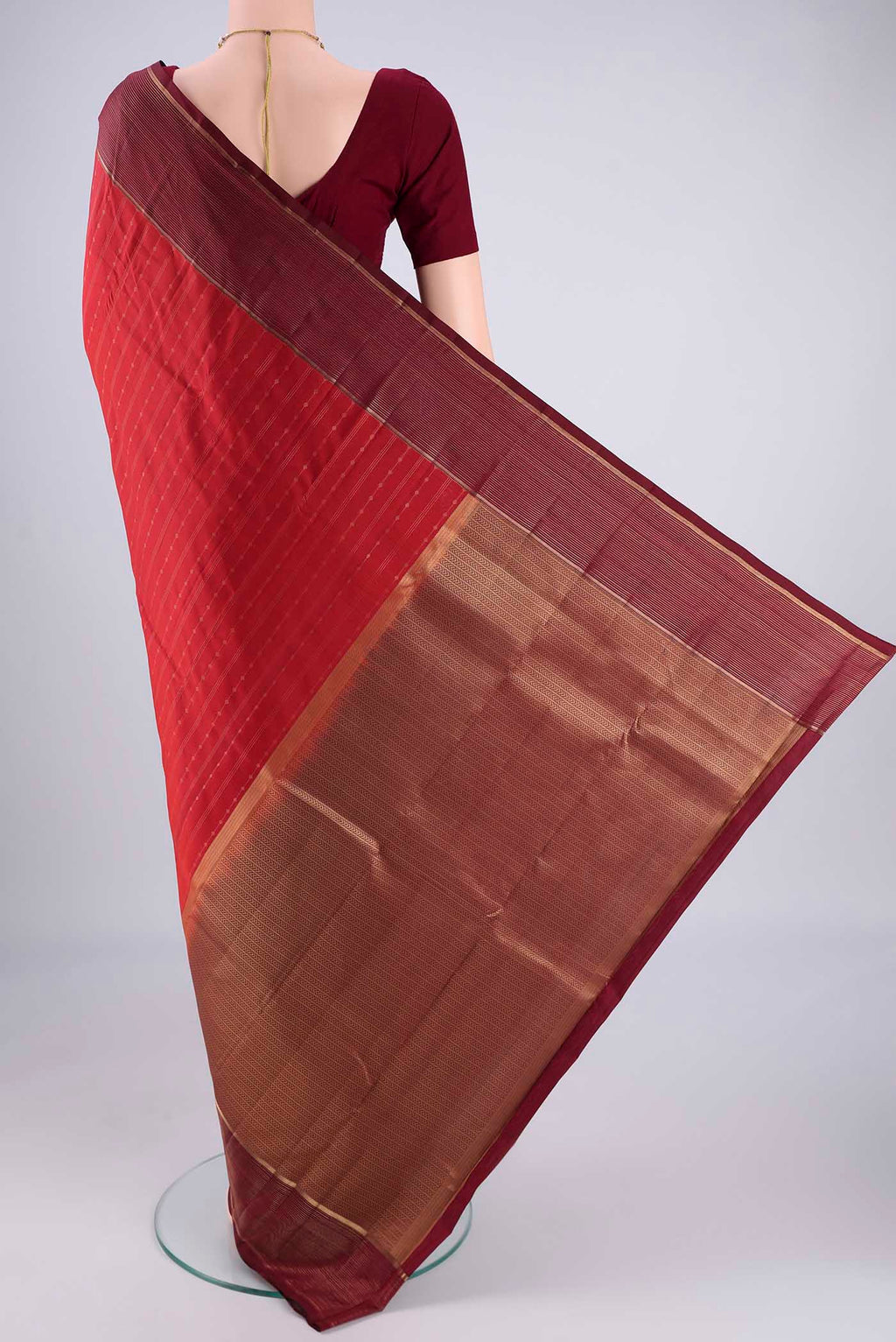 Flat view of Red Kanchipuram Silk Saree with Stripes on the body and Zari Border. 