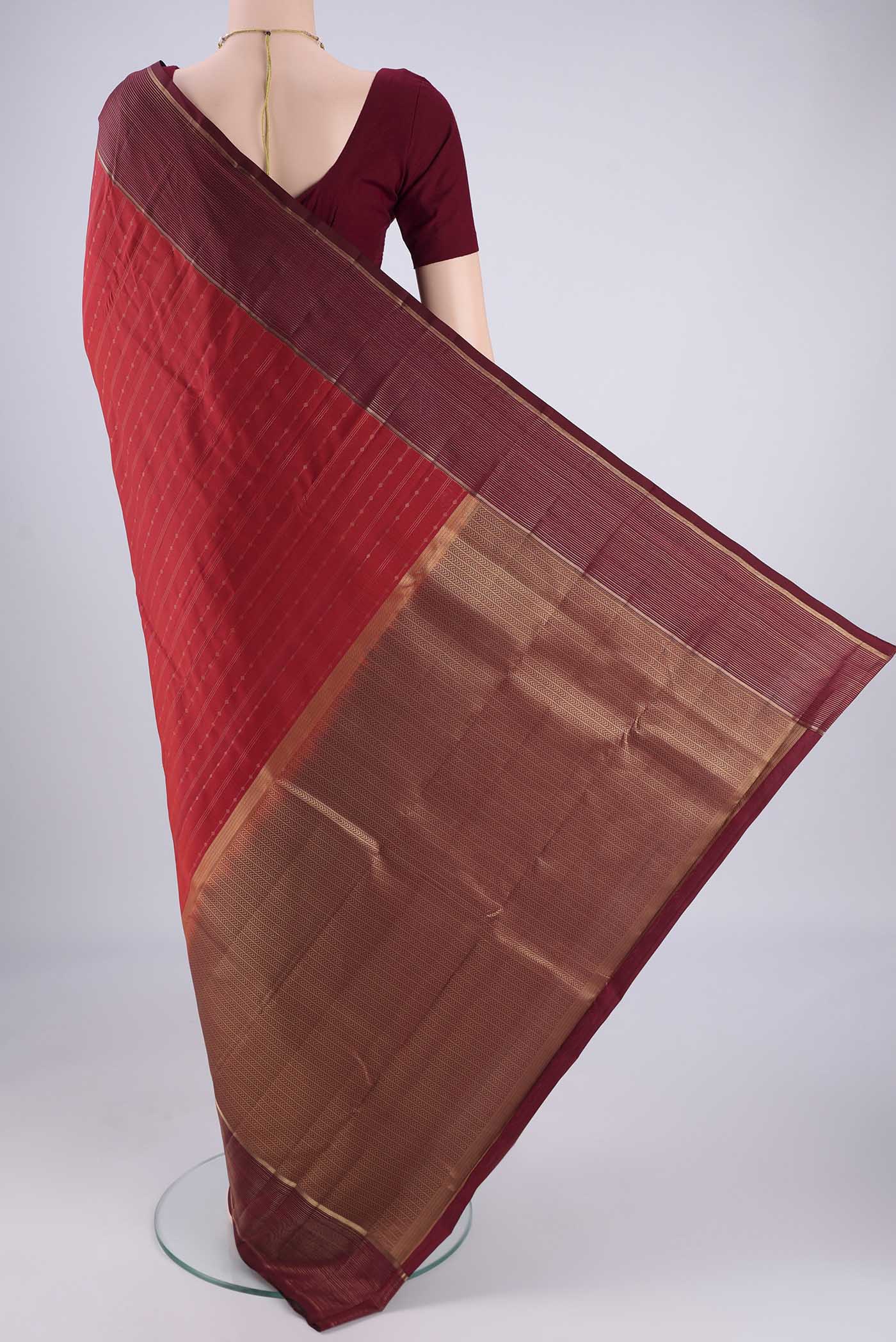 Flat view of Red Kanchipuram Silk Saree with Stripes on the body and Zari Border. 