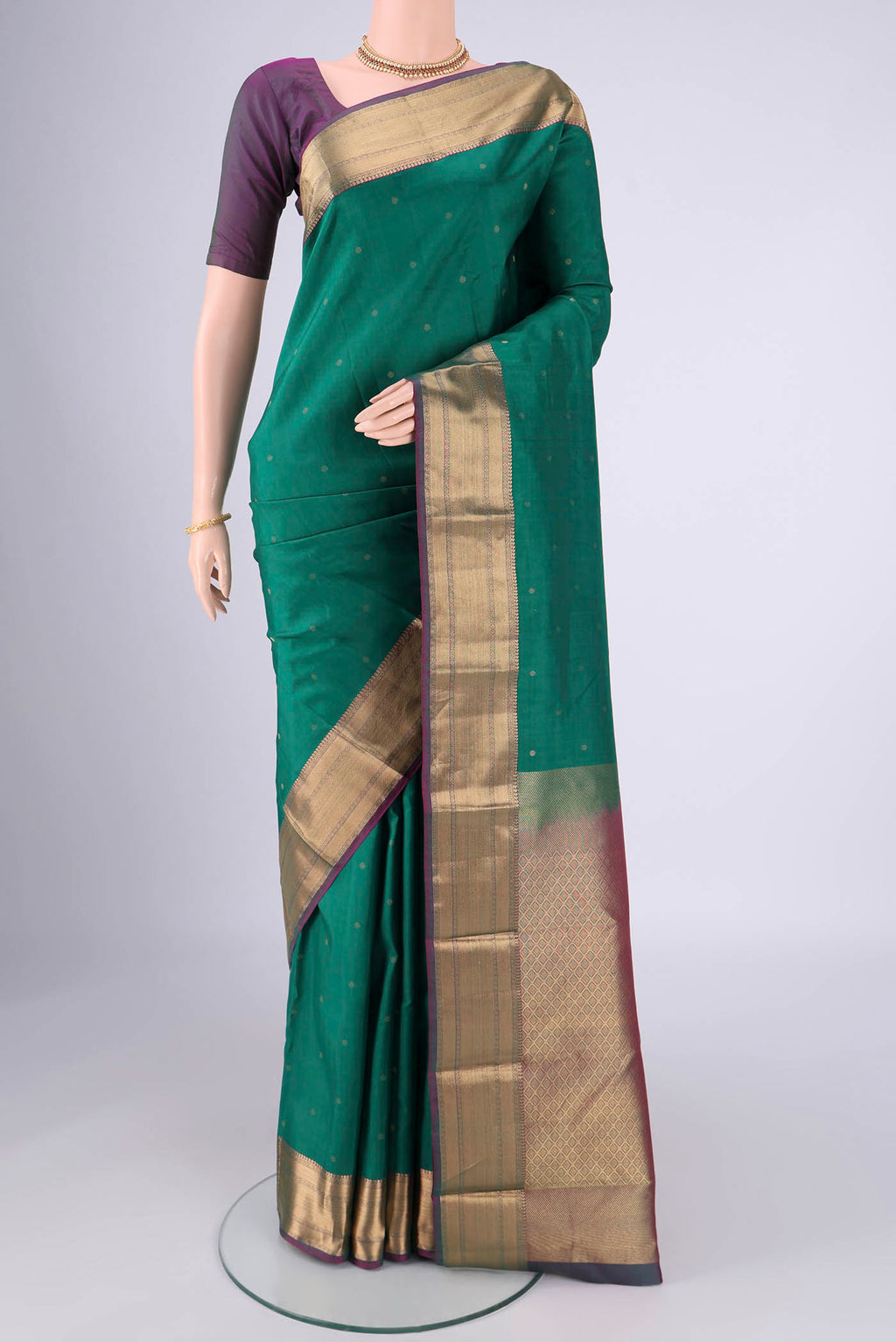 Sea Green Kanchipuram Silk Saree with Zari Butta on the body and Zari Border.  displayed on a mannequin