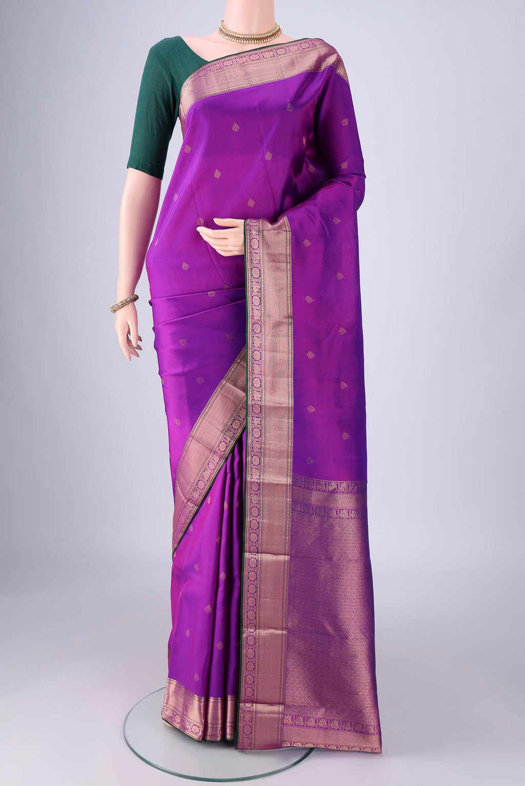 Purple Kanchipuram Silk Saree with Zari Butta on the body and Zari Border.  displayed on a mannequin