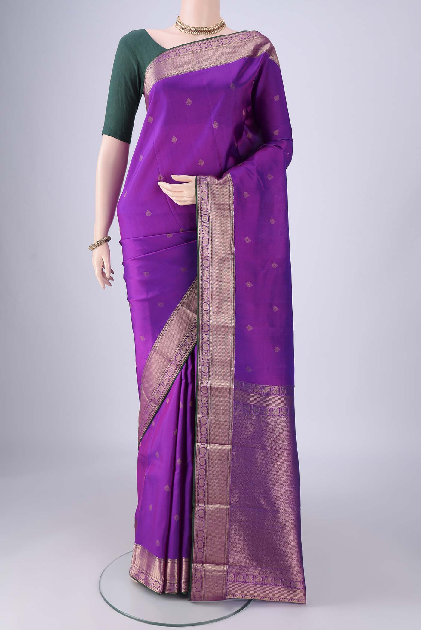 Purple Kanchipuram Silk Saree with Zari Butta on the body and Zari Border.  displayed on a mannequin