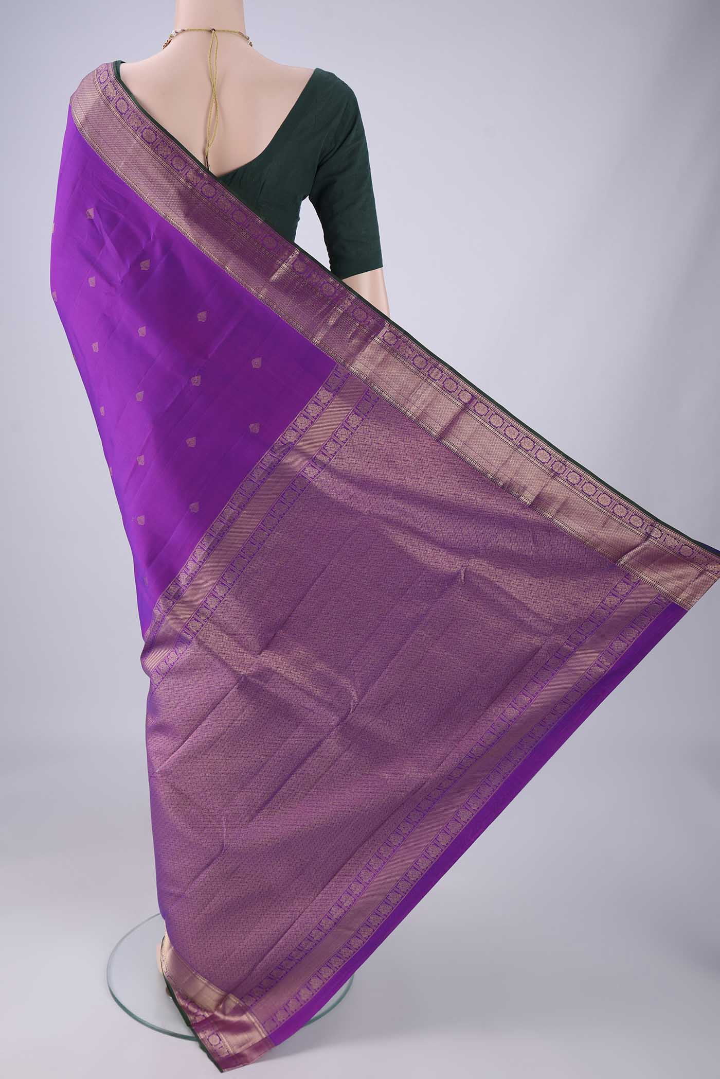 Flat view of Purple Kanchipuram Silk Saree with Zari Butta on the body and Zari Border. 