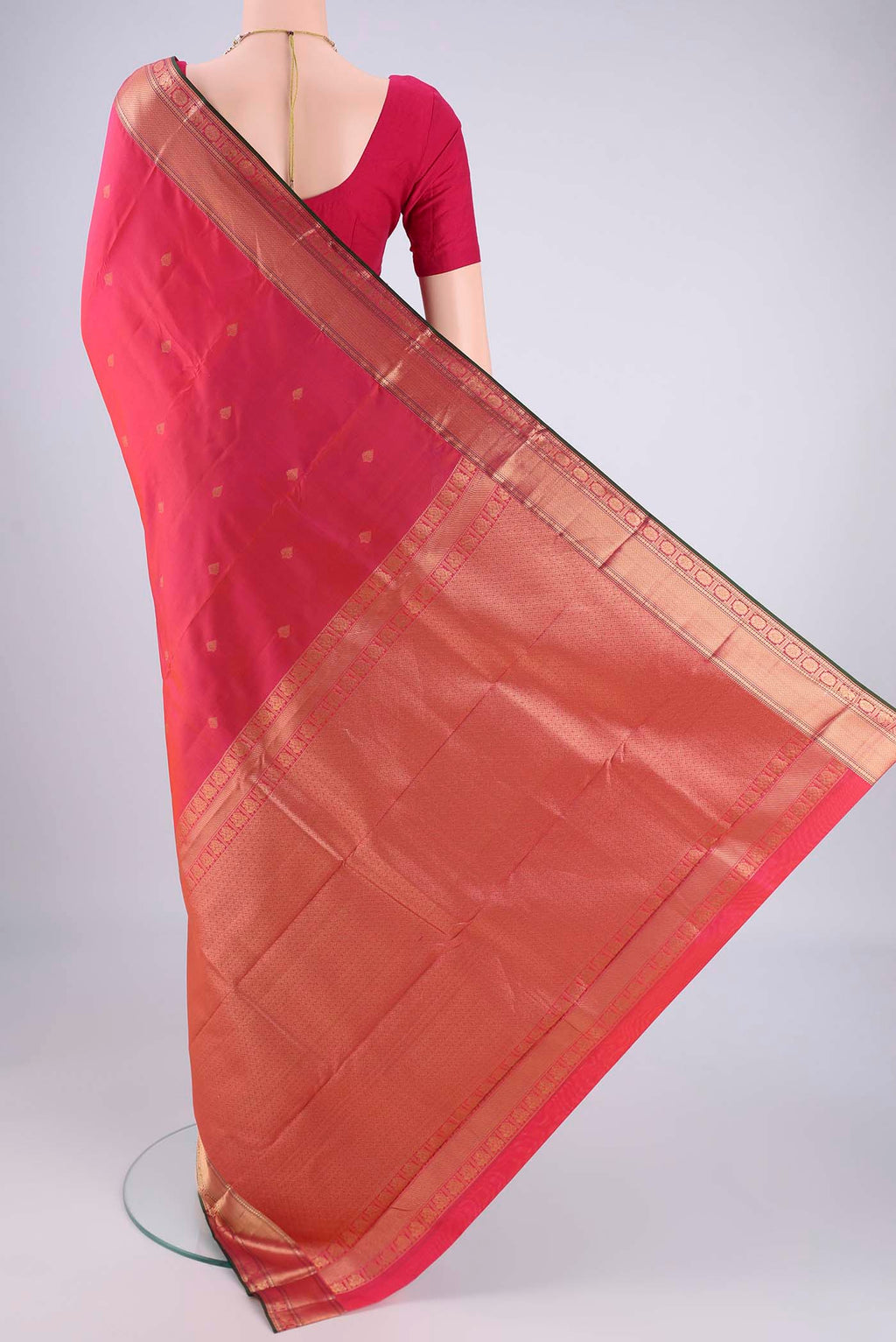 Flat view of Pink Kanchipuram Silk Saree with Zari Butta on the body and Zari Border. 
