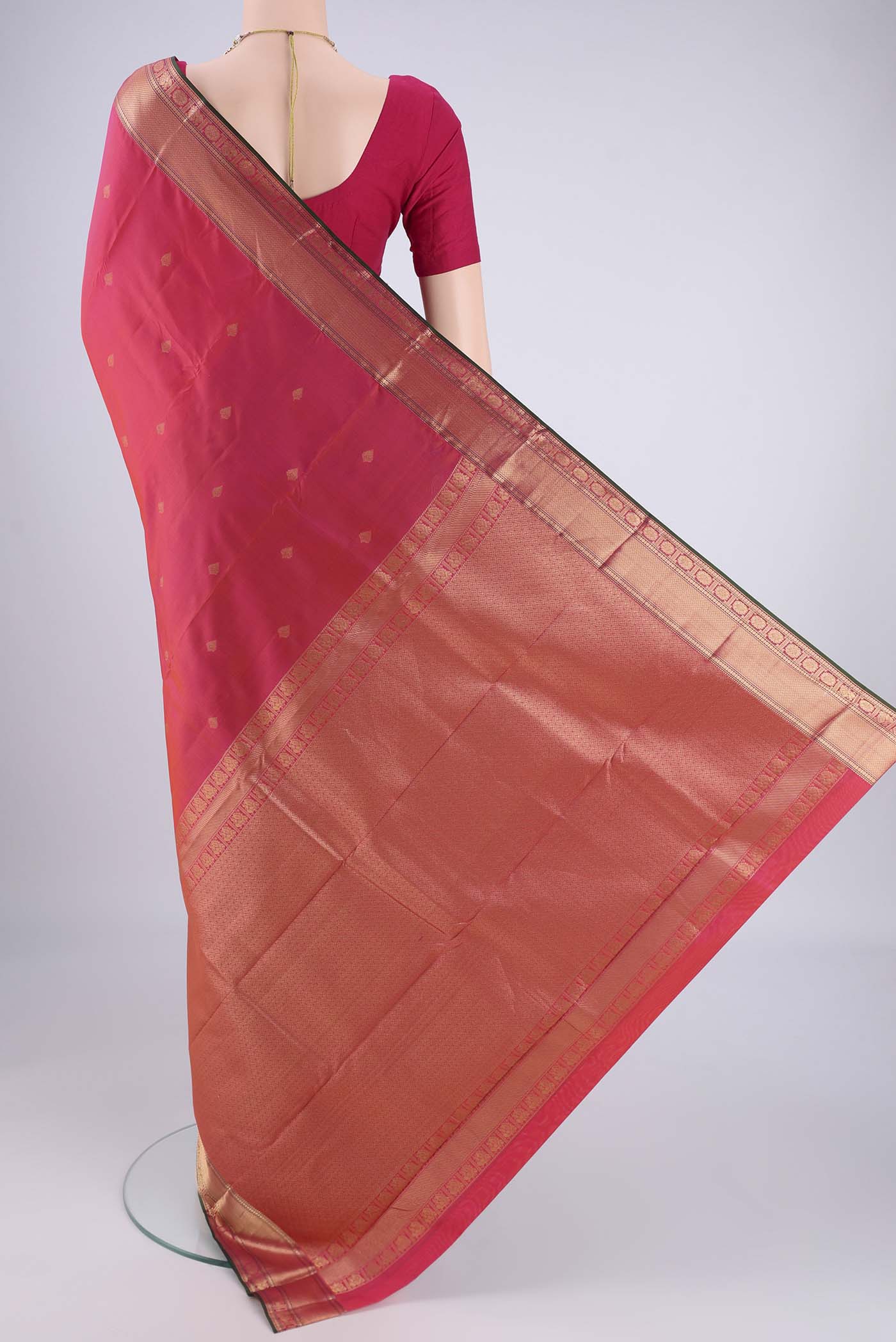Flat view of Pink Kanchipuram Silk Saree with Zari Butta on the body and Zari Border. 