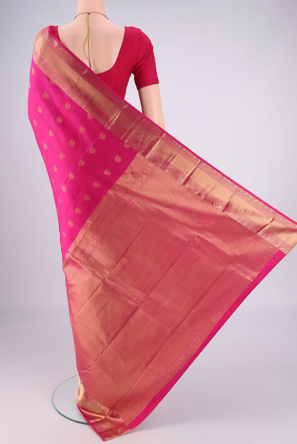 Flat view of Pink Kanchipuram Silk Saree with Zari Butta on the body and Zari Border. 