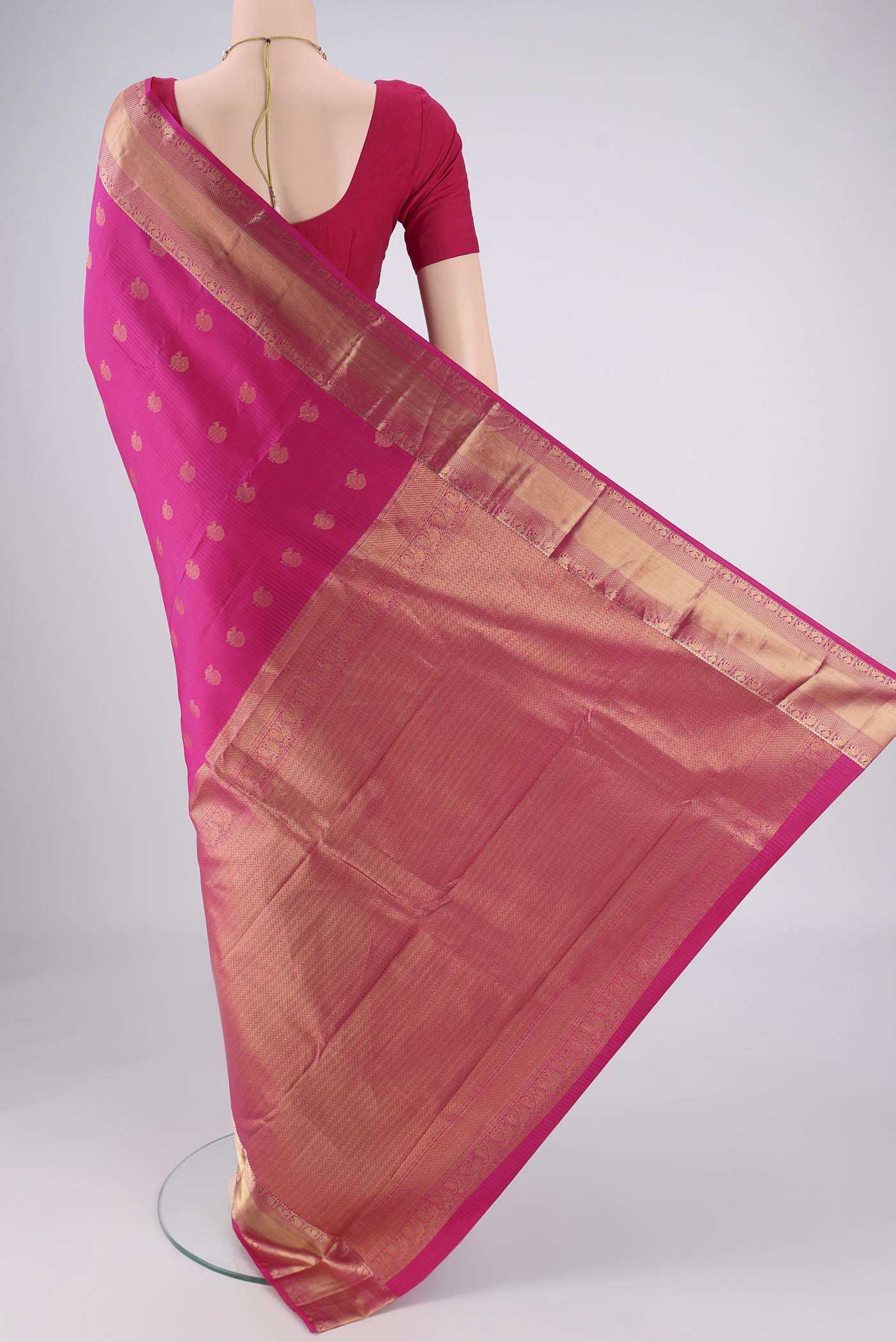 Flat view of Pink Kanchipuram Silk Saree with Zari Butta on the body and Zari Border. 