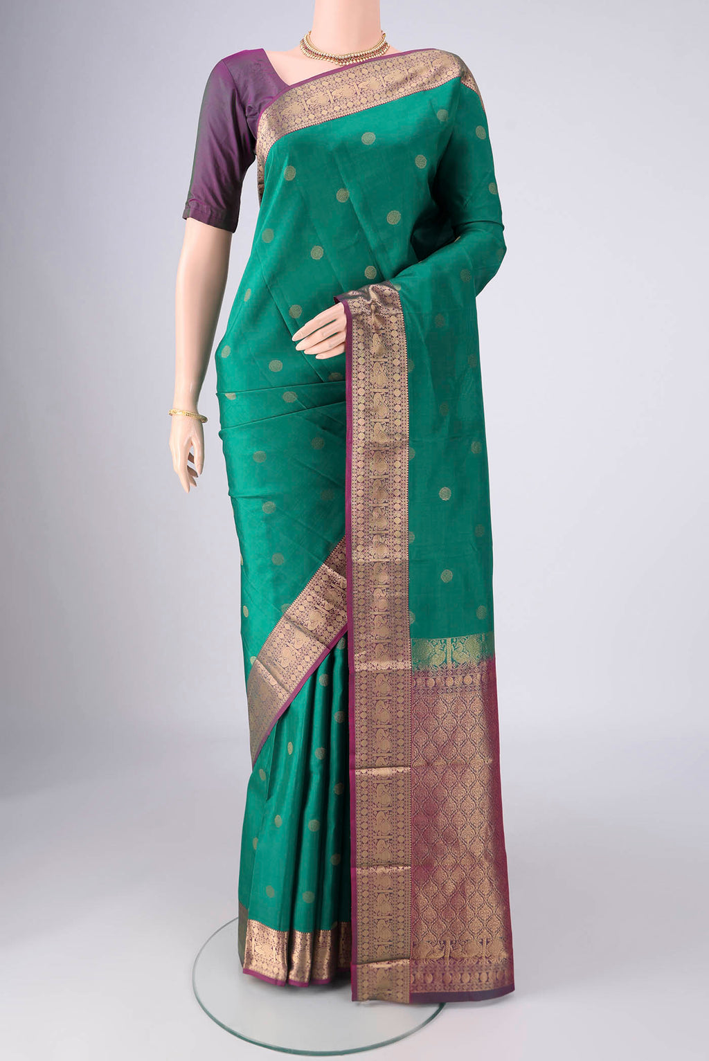 Sea Green Kanchipuram Silk Saree with Zari Butta on the body and Zari Border.  displayed on a mannequin