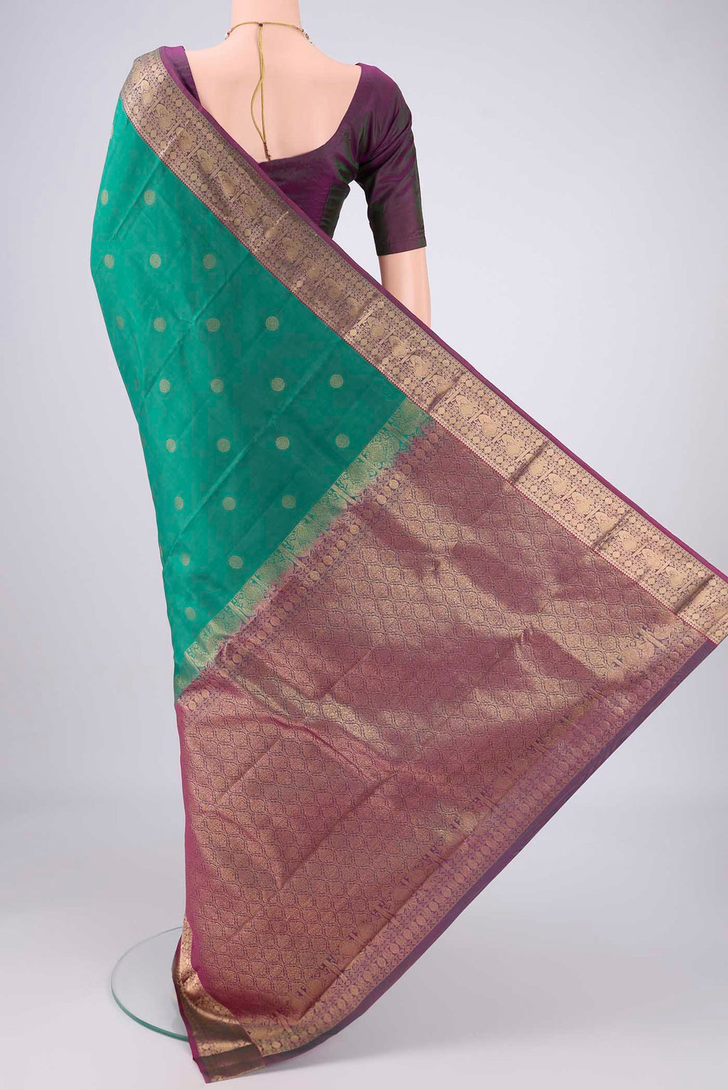 Flat view of Sea Green Kanchipuram Silk Saree with Zari Butta on the body and Zari Border. 