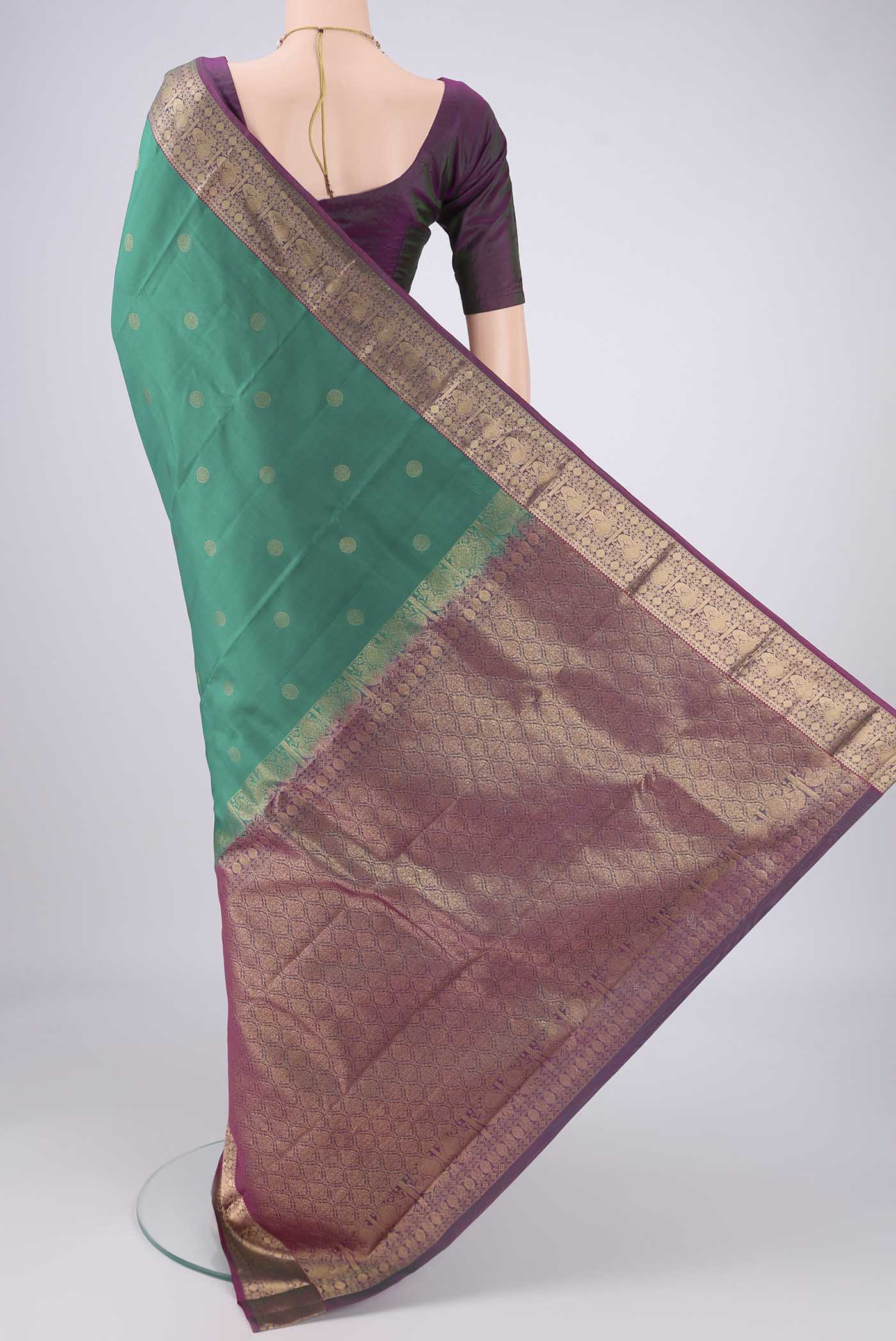 Flat view of Sea Green Kanchipuram Silk Saree with Zari Butta on the body and Zari Border. 