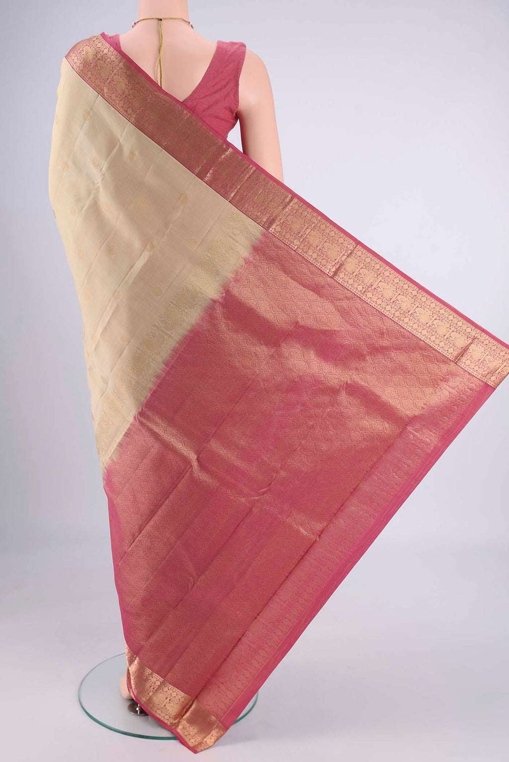 Flat view of Beige Kanchipuram Silk Saree with Zari Butta on the body and Zari Border. 