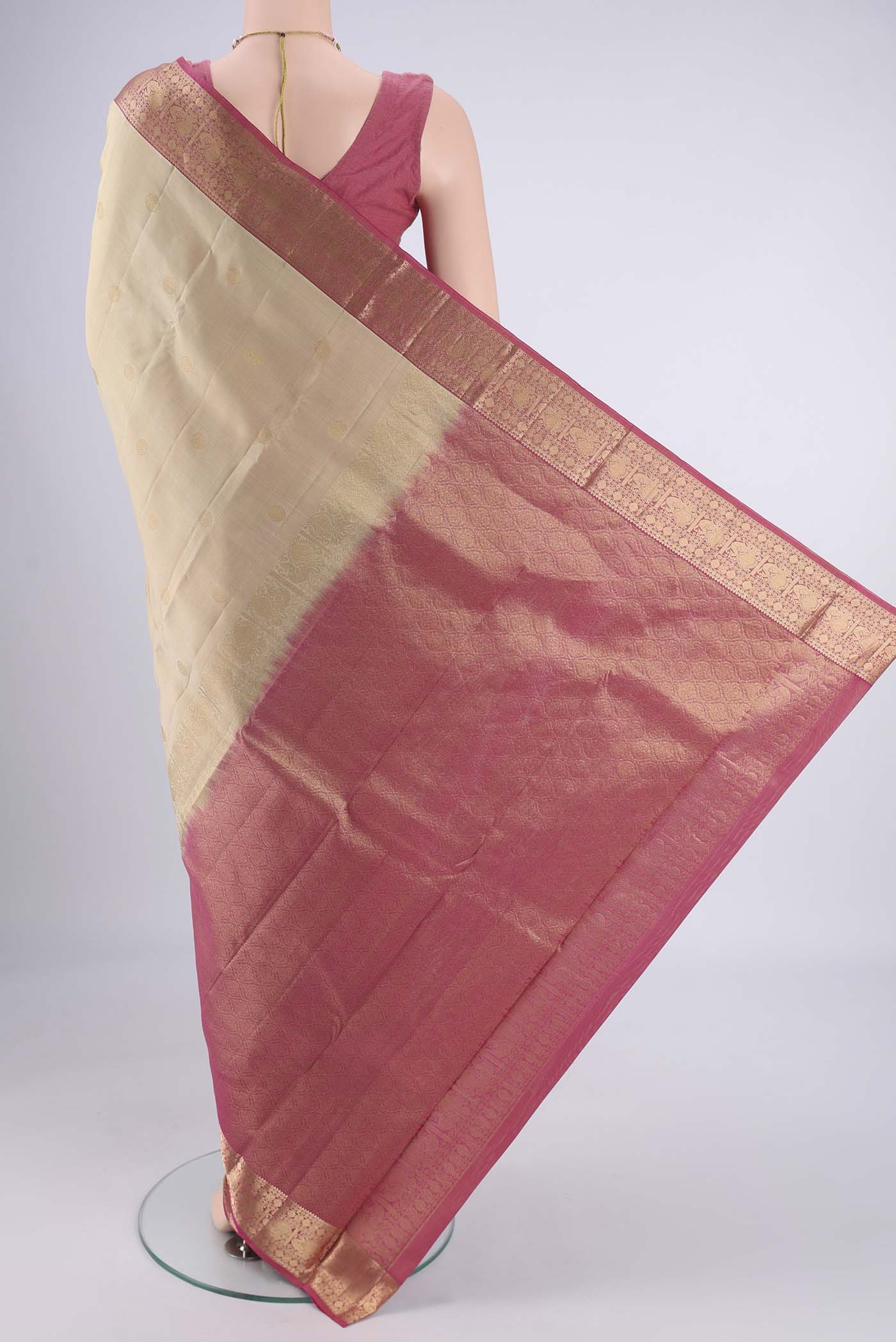 Flat view of Beige Kanchipuram Silk Saree with Zari Butta on the body and Zari Border. 