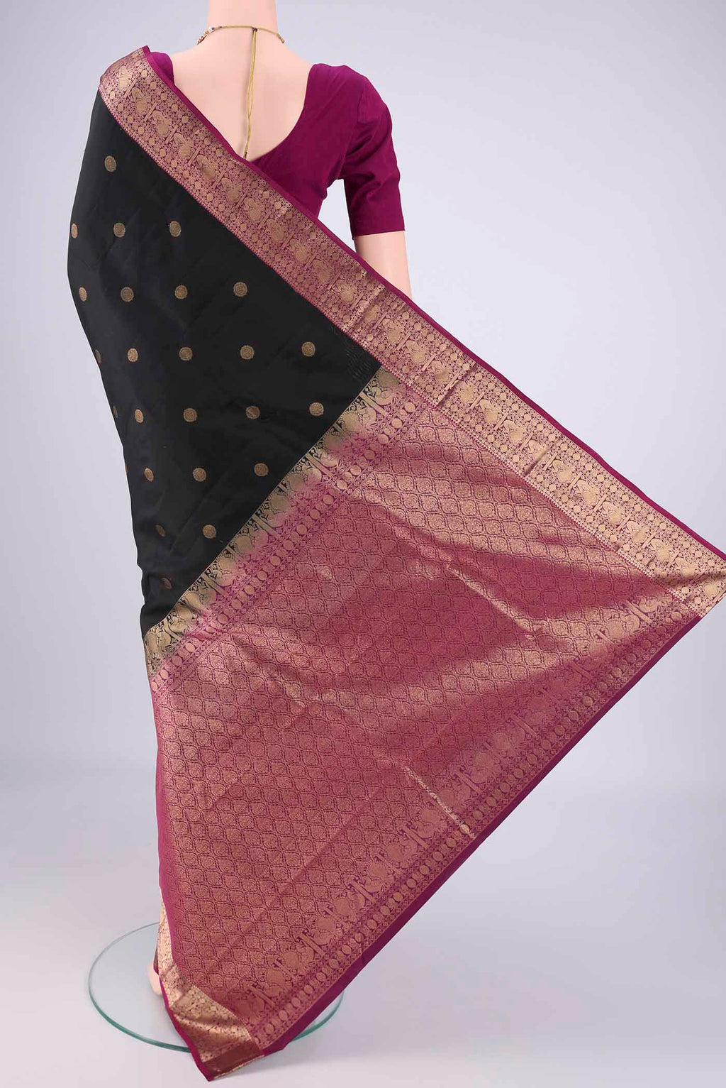 Flat view of Black Kanchipuram Silk Saree with Zari Butta on the body and Zari Border. 