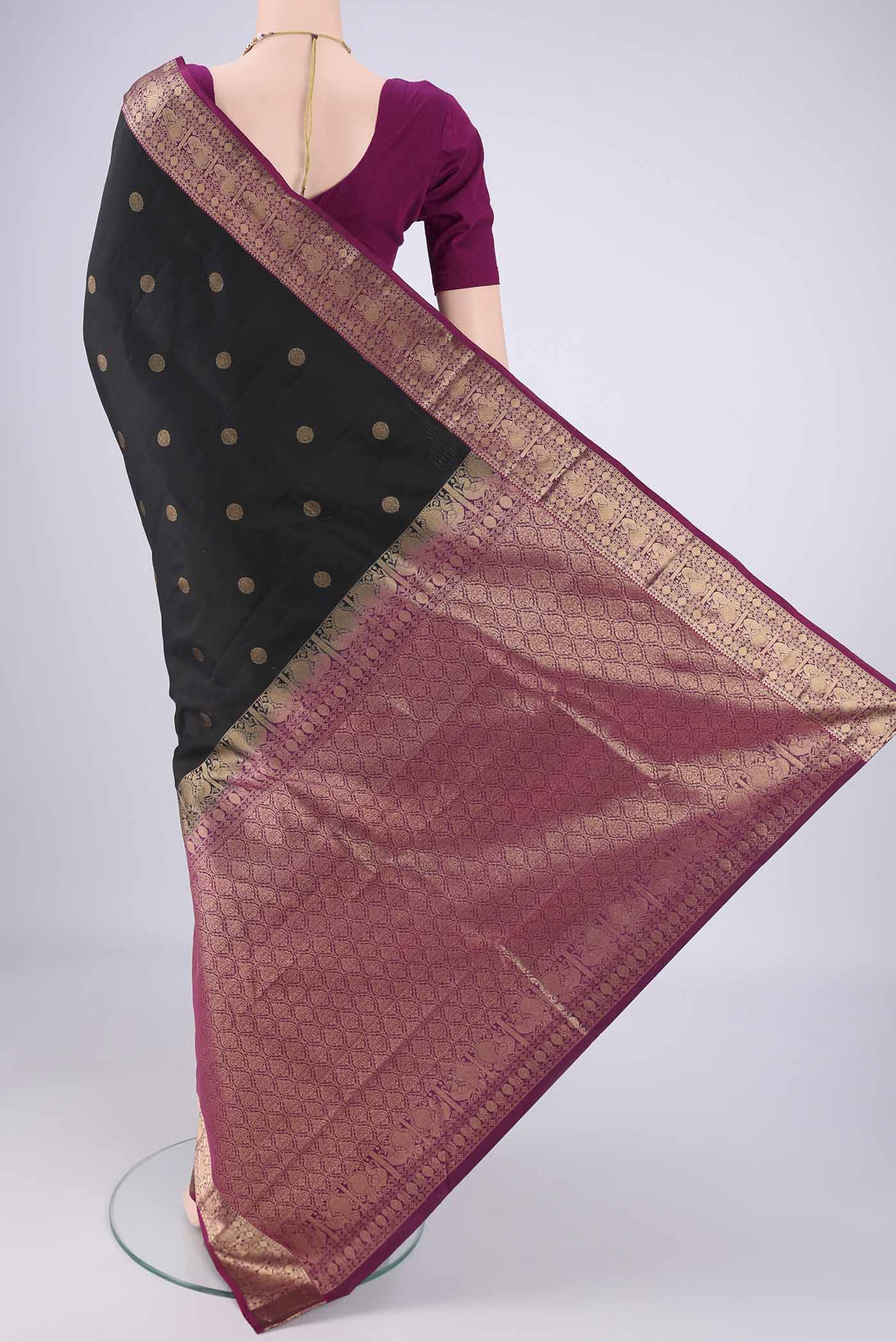 Flat view of Black Kanchipuram Silk Saree with Zari Butta on the body and Zari Border. 
