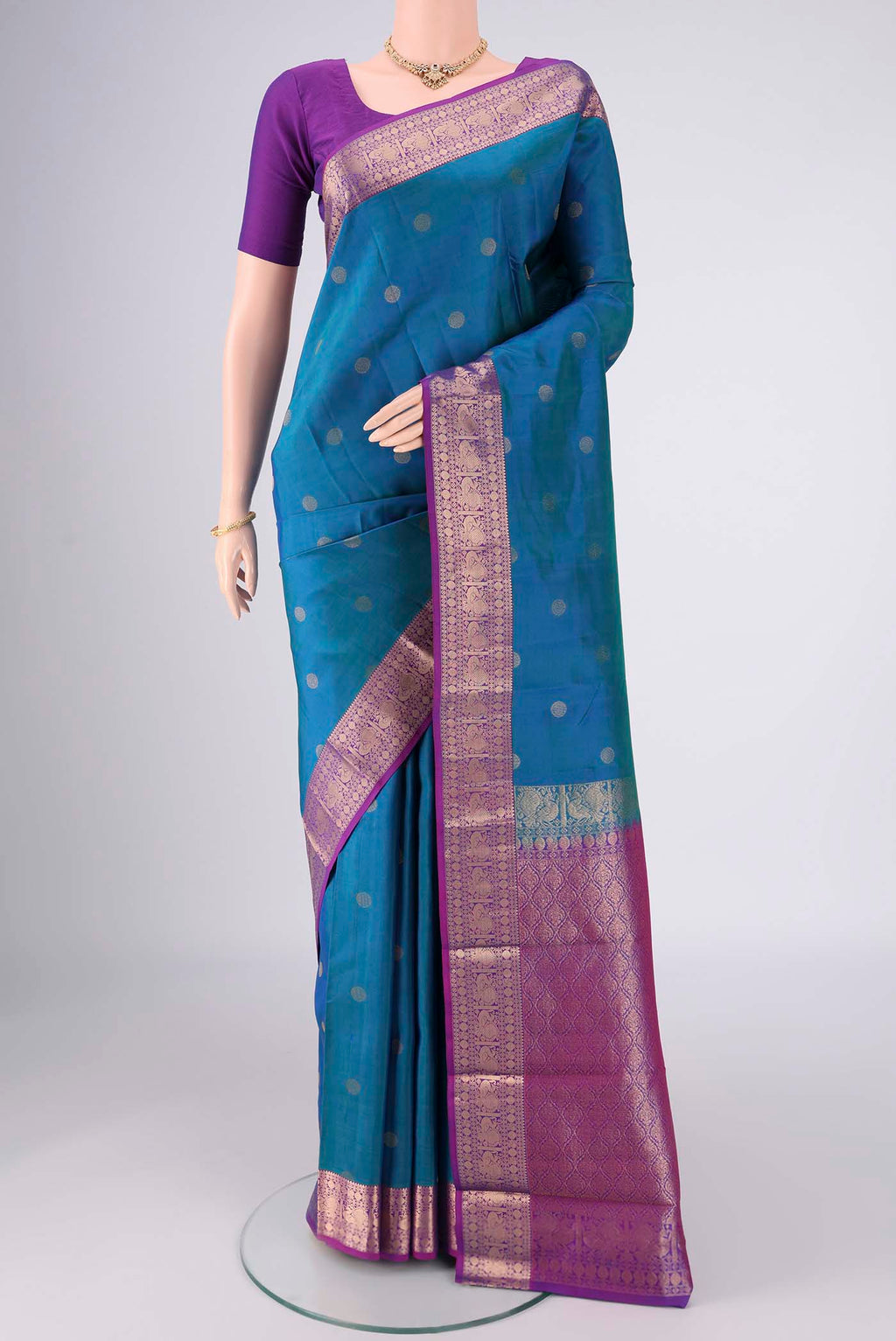 Blue Kanchipuram Silk Saree with Zari Butta on the body and Zari Border.  displayed on a mannequin