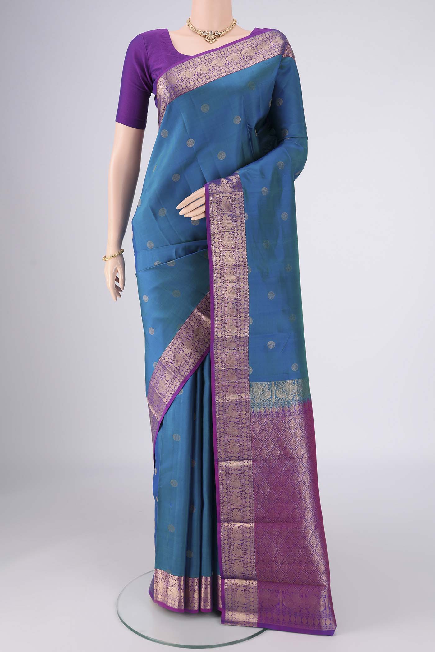Blue Kanchipuram Silk Saree with Zari Butta on the body and Zari Border.  displayed on a mannequin
