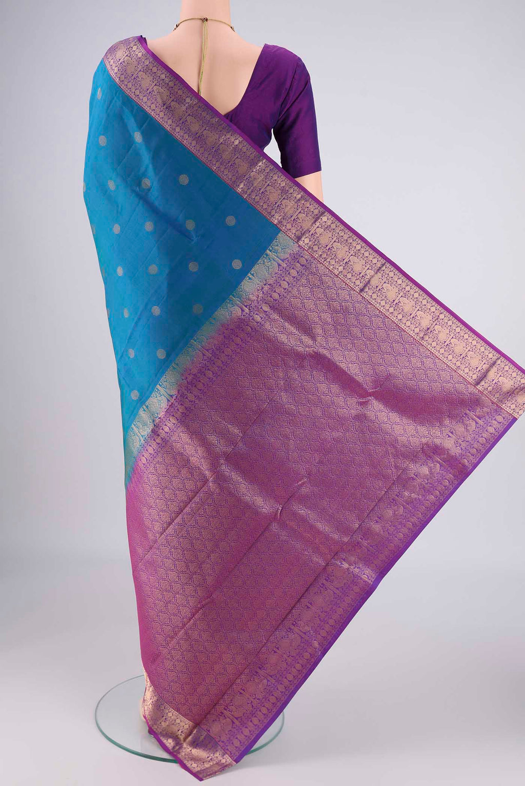 Flat view of Blue Kanchipuram Silk Saree with Zari Butta on the body and Zari Border. 