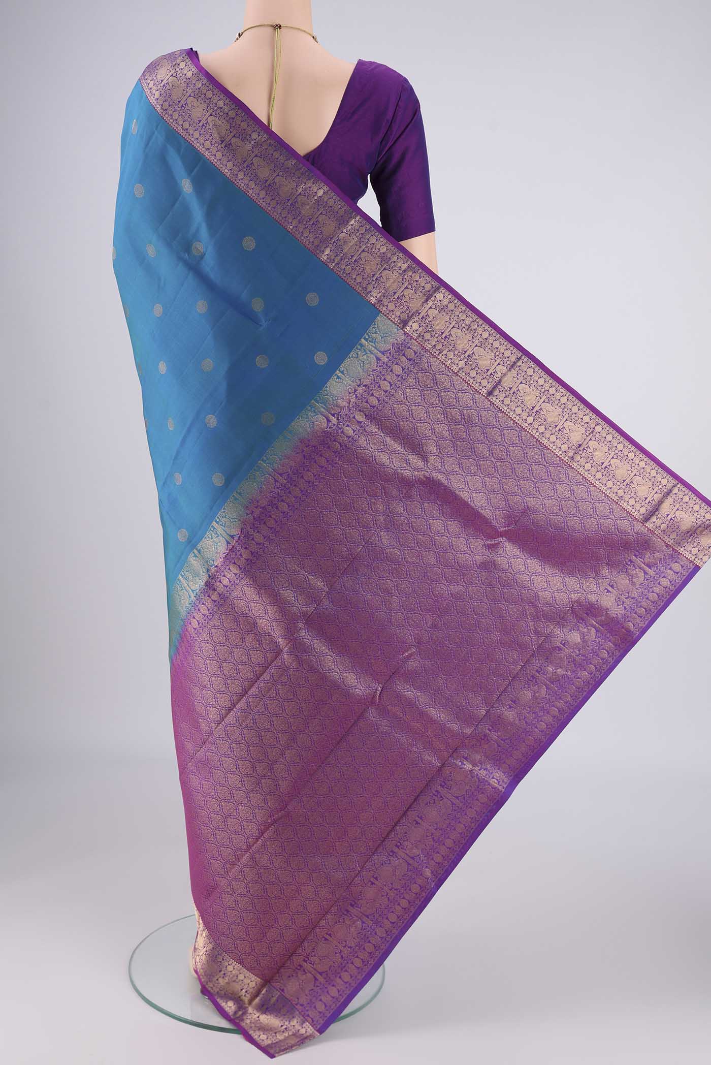 Flat view of Blue Kanchipuram Silk Saree with Zari Butta on the body and Zari Border. 