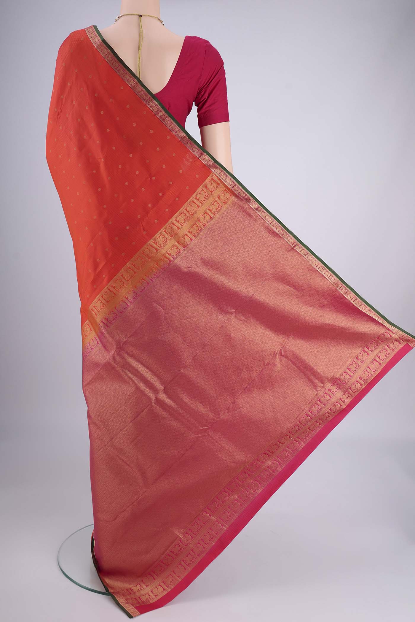 Flat view of Orange Kanjivaram Silk Saree with Zari Butta on the body and Zari Border. 