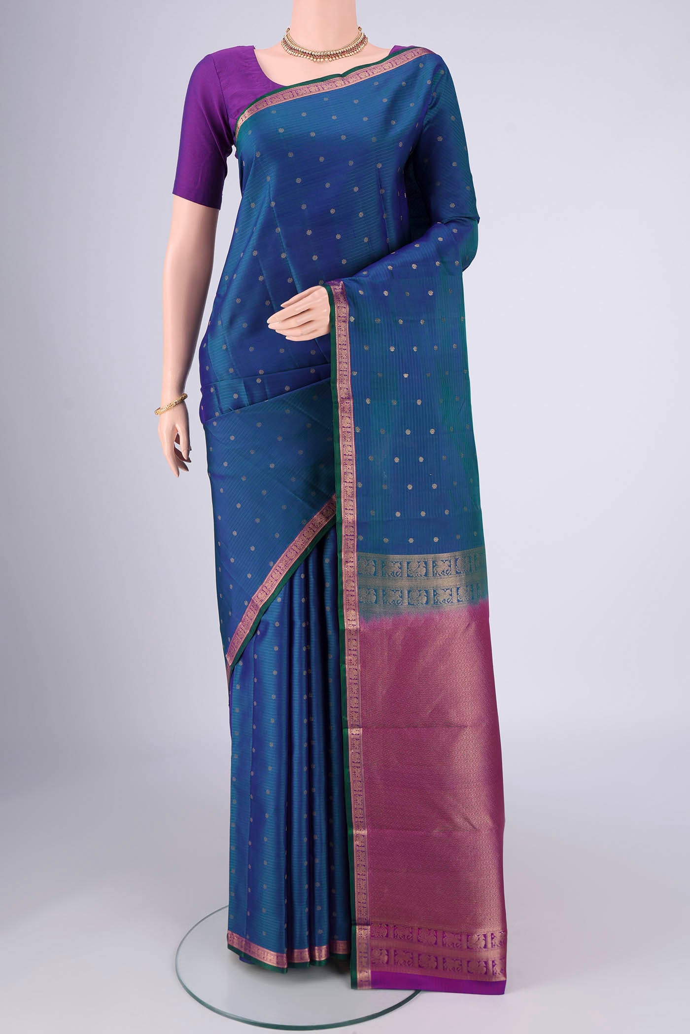 Peacock Blue Dual Tone Kanjivaram Silk Saree with Zari Butta on the body and Zari Border.  displayed on a mannequin