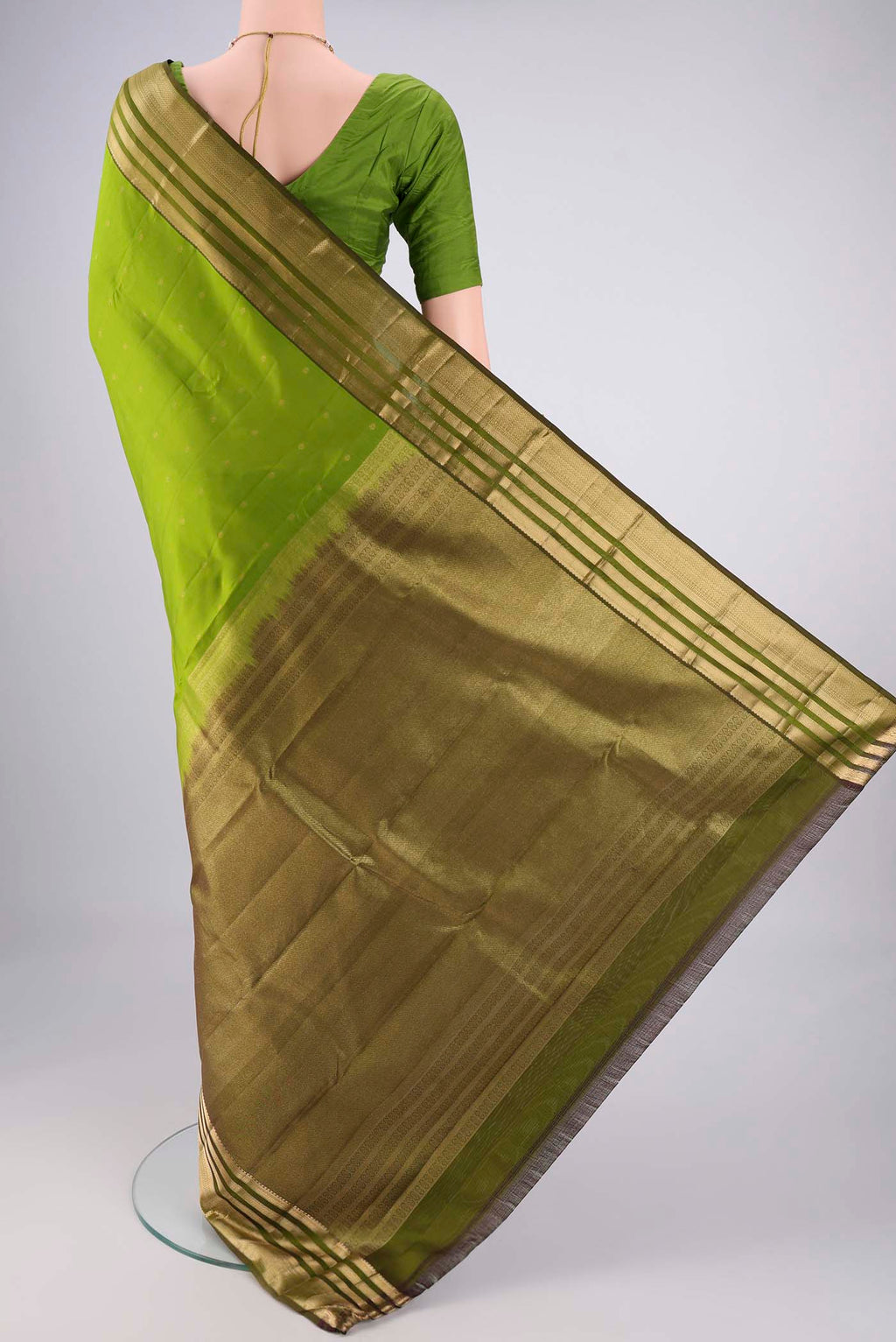 Flat view of Green Kanchipuram Silk Saree with Zari Butta on the body and Zari Border. 