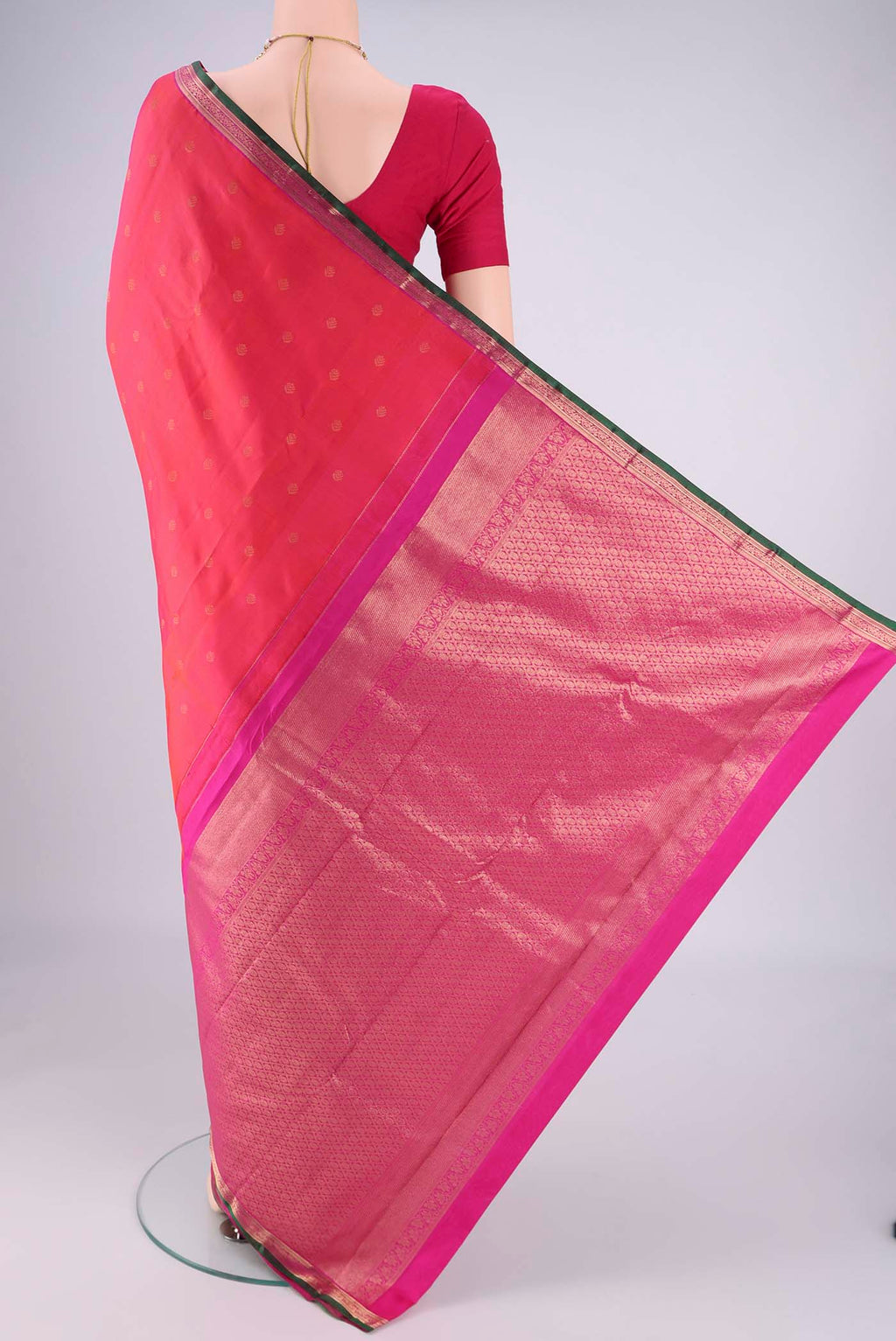 Flat view of Coral Kanchipuram Silk Saree with Zari Butta on the body and Zari Border. 