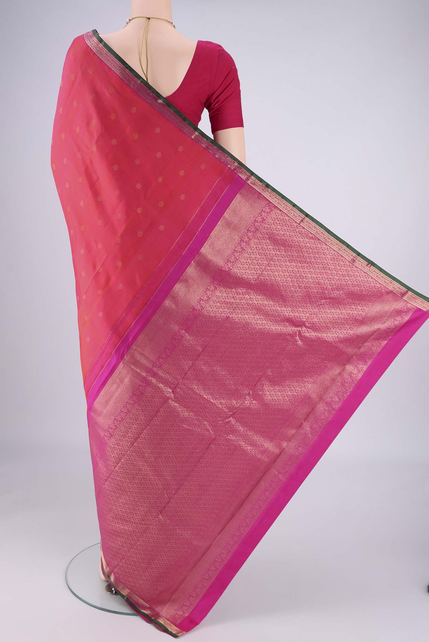 Flat view of Coral Kanchipuram Silk Saree with Zari Butta on the body and Zari Border. 