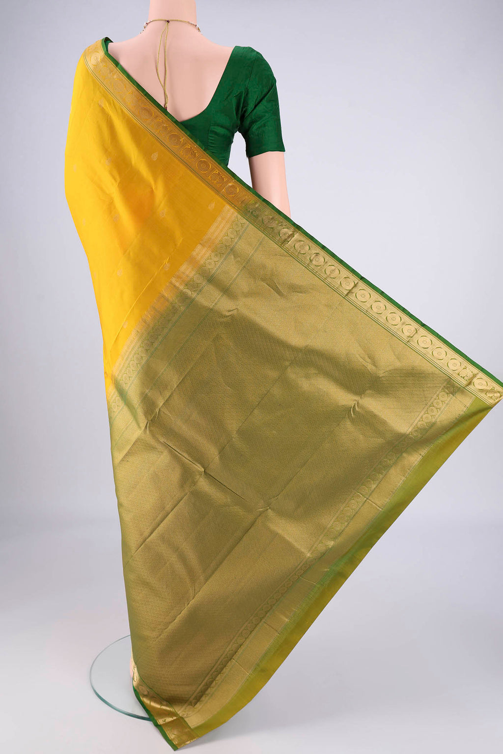 Flat view of Yellow Kanchipuram Silk Saree with Zari Butta on the body and Zari Border. 