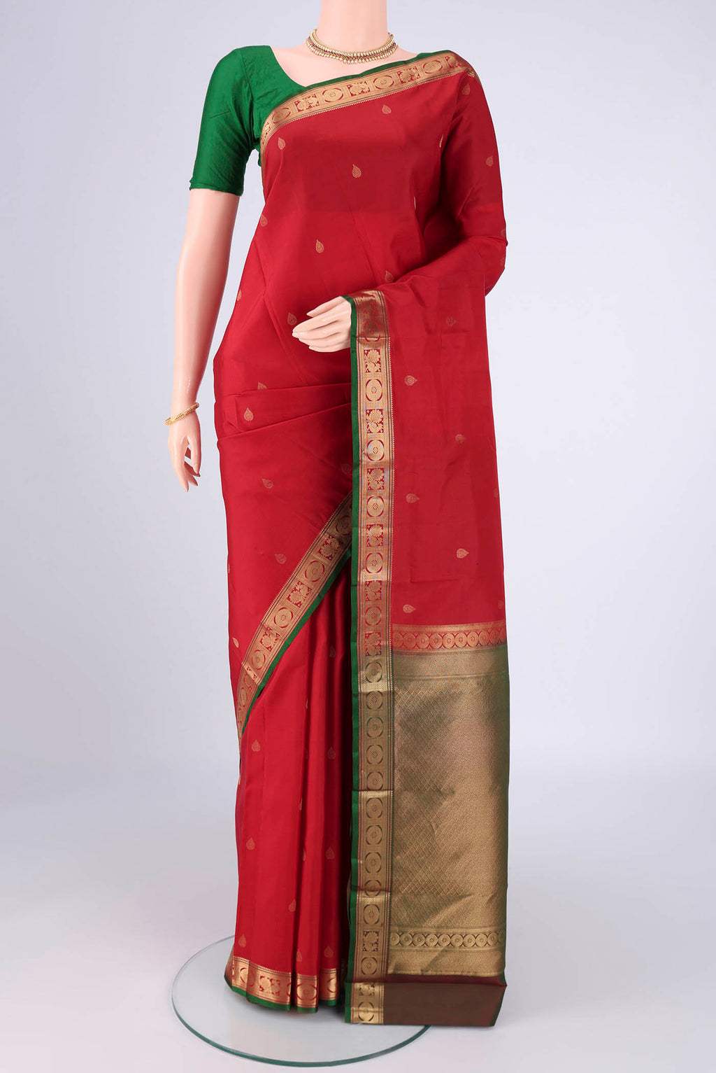 Deep Red Kanchipuram Silk Saree with Zari Butta on the body and Zari Border.  displayed on a mannequin