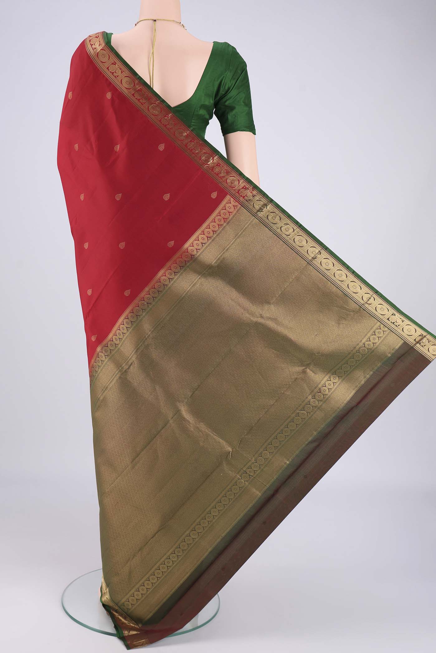 Flat view of Deep Red Kanchipuram Silk Saree with Zari Butta on the body and Zari Border. 