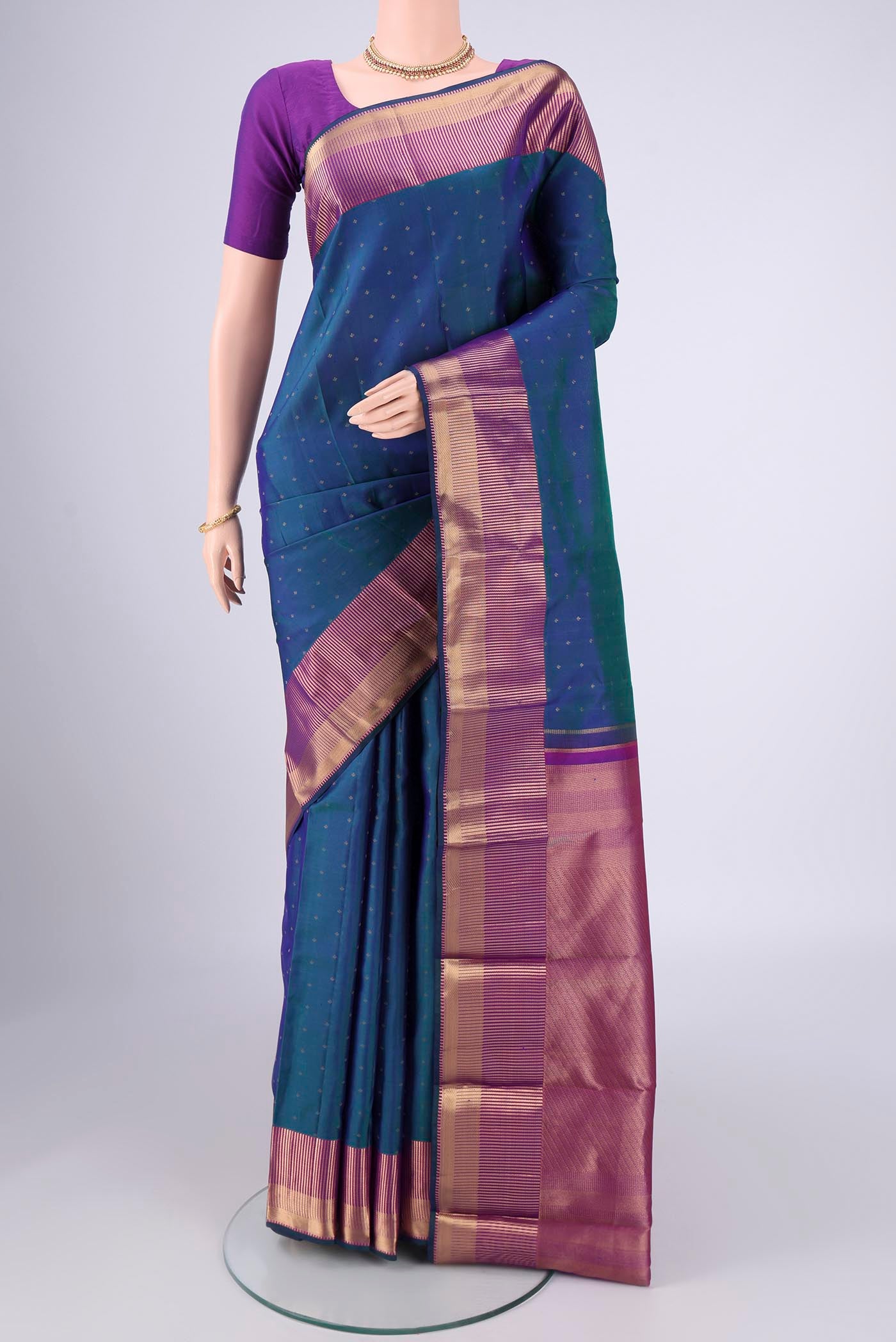 Peacock Blue Dual Tone Kanchipuram Silk Saree with Zari Butta on the body and Zari Border.  displayed on a mannequin