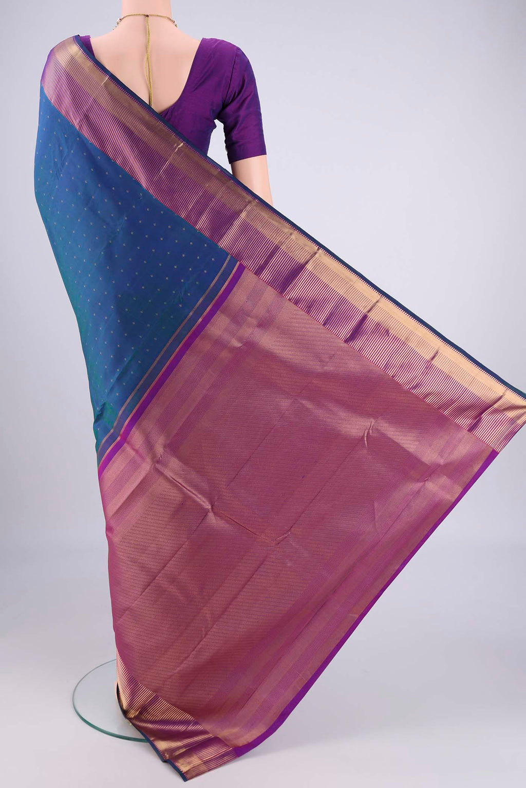 Flat view of Peacock Blue Dual Tone Kanchipuram Silk Saree with Zari Butta on the body and Zari Border. 