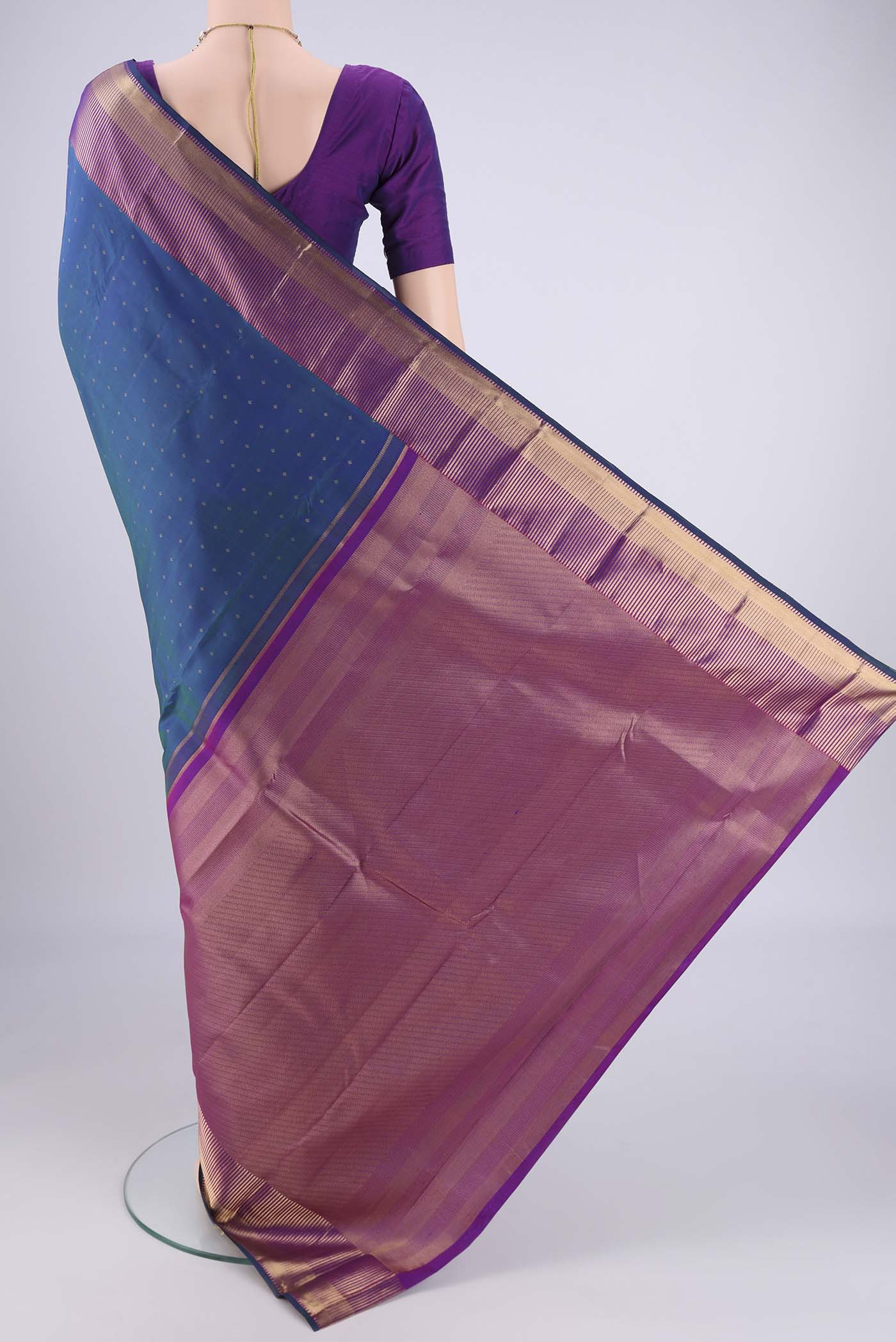 Flat view of Peacock Blue Dual Tone Kanchipuram Silk Saree with Zari Butta on the body and Zari Border. 
