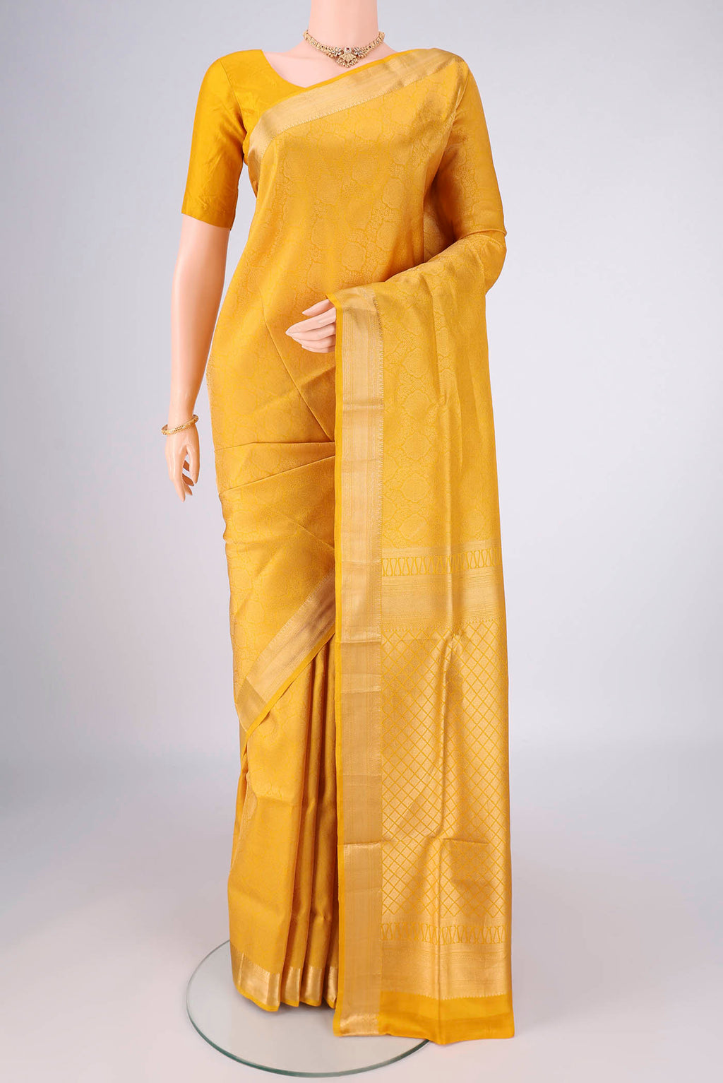 Yellow Soft Silk Saree with Zari Brocade on the body and Zari Border.  displayed on a mannequin