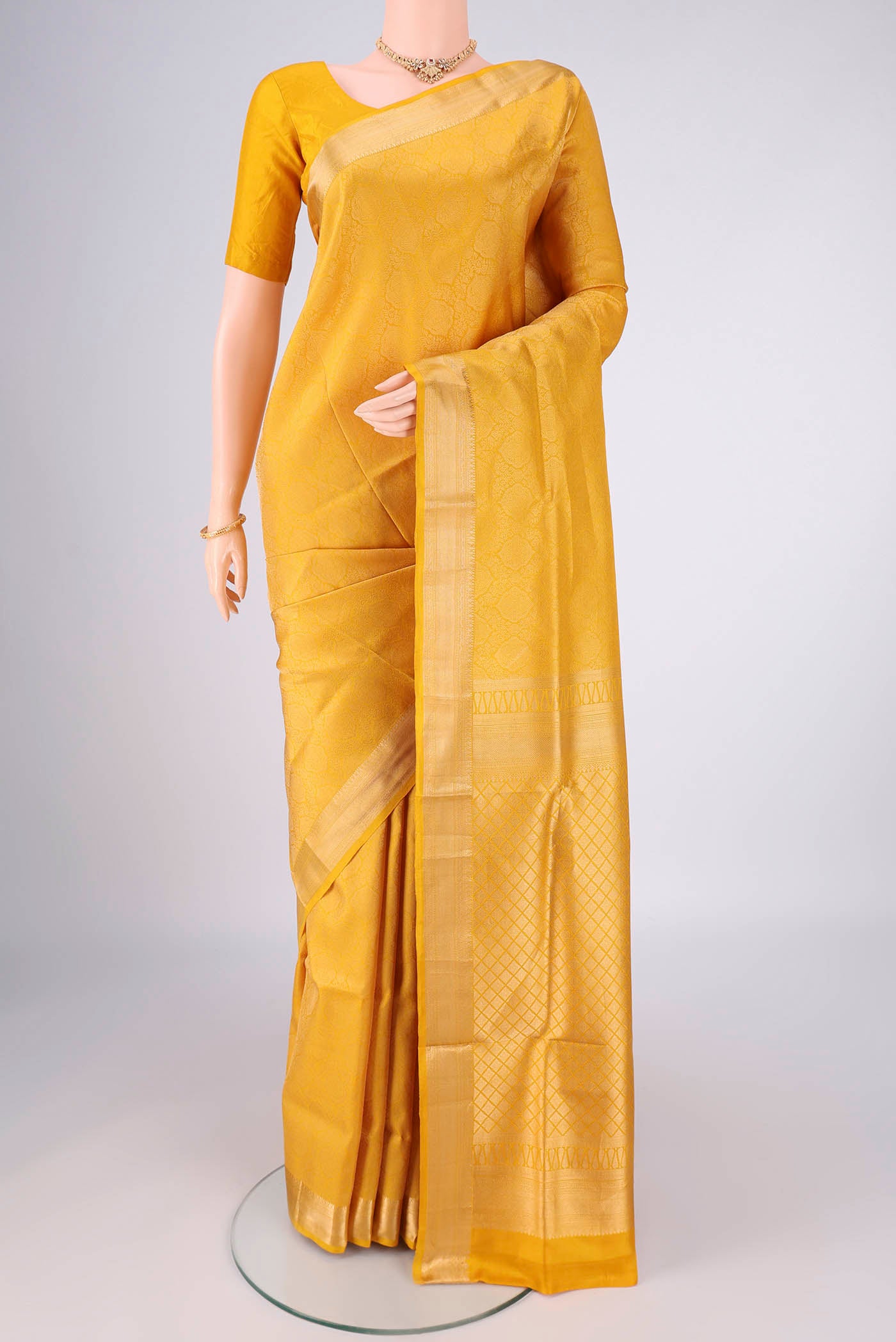 Yellow Soft Silk Saree with Zari Brocade on the body and Zari Border.  displayed on a mannequin