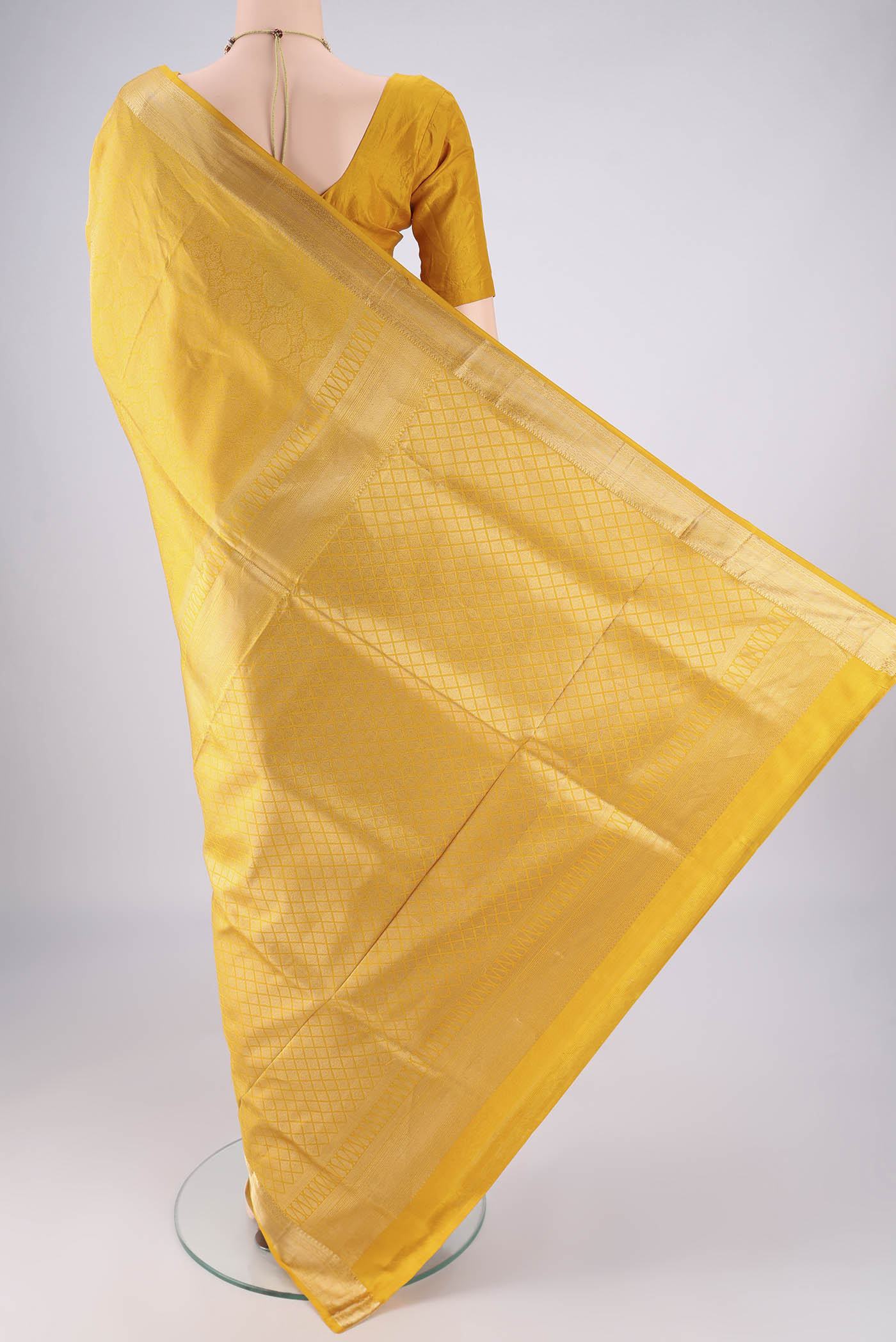Flat view of Yellow Soft Silk Saree with Zari Brocade on the body and Zari Border. 