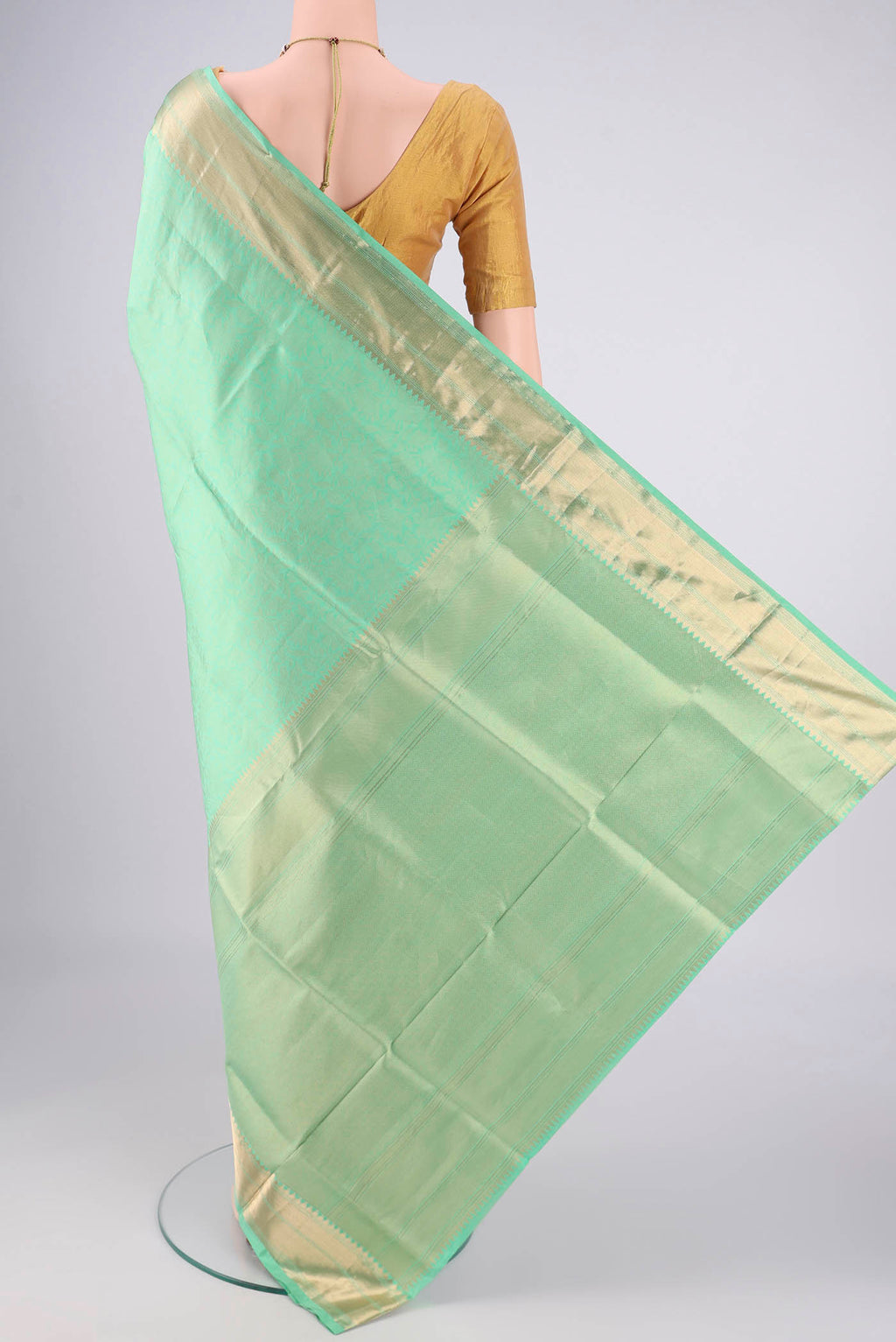 Flat view of Mint Green Soft Silk Saree with Zari Brocade on the body and Zari Border. 
