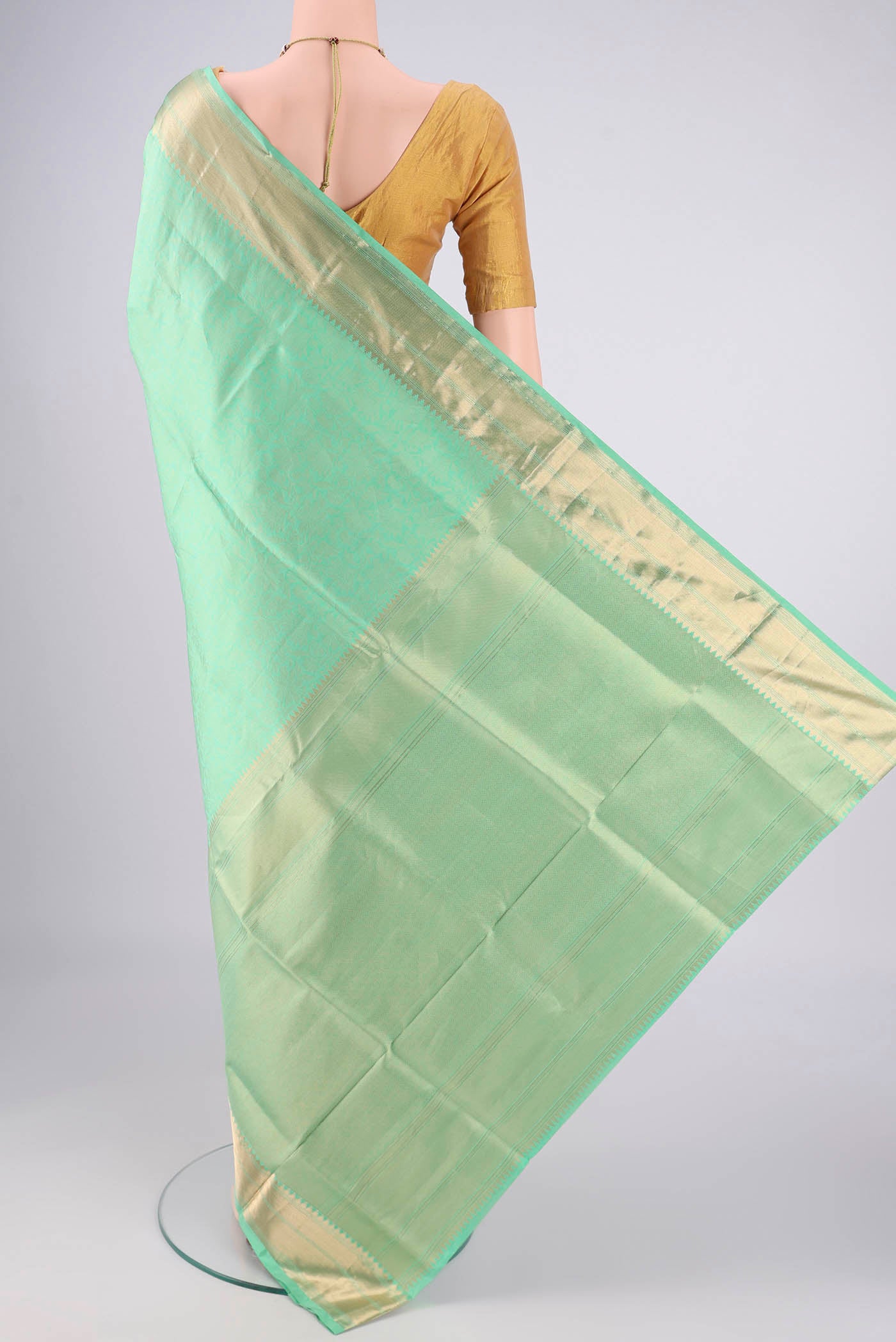 Flat view of Mint Green Soft Silk Saree with Zari Brocade on the body and Zari Border. 