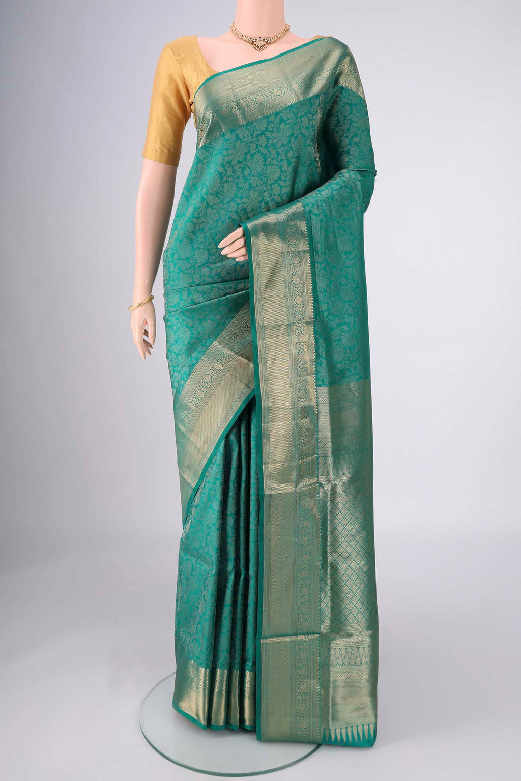 Sea Green Soft Silk Saree with Zari Brocade on the body and Zari Border.  displayed on a mannequin