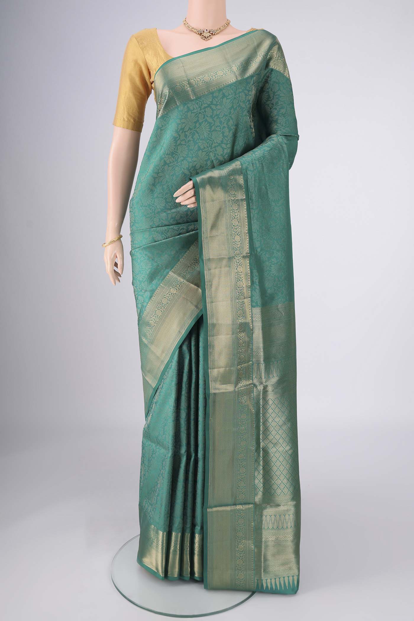 Sea Green Soft Silk Saree with Zari Brocade on the body and Zari Border.  displayed on a mannequin