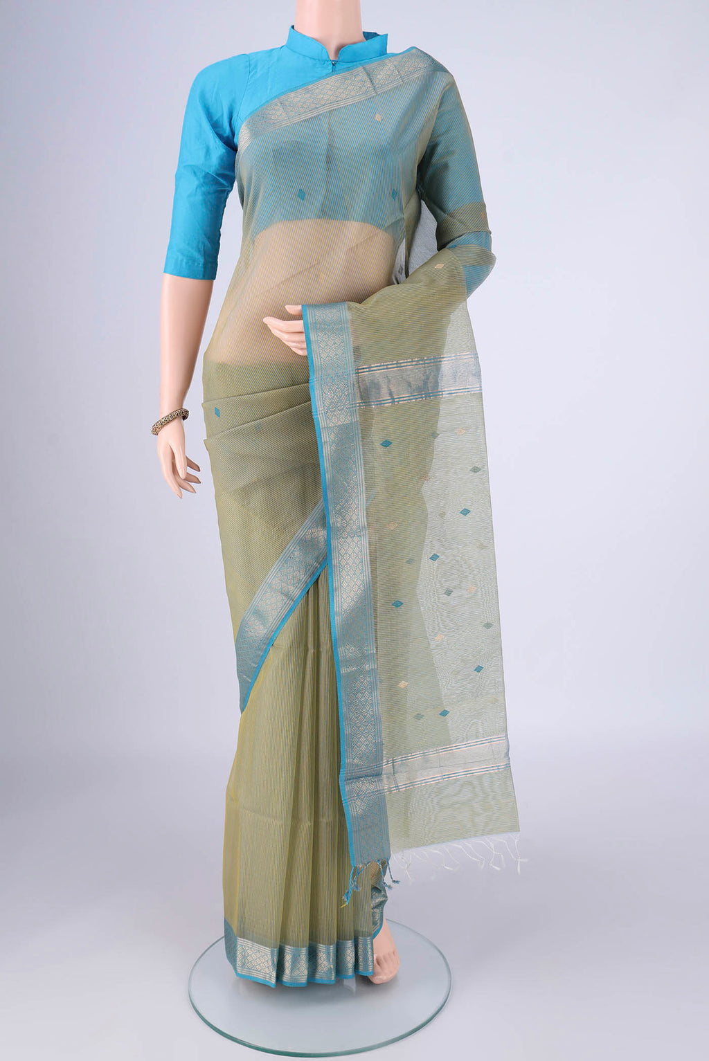 Light Green Dual Tone Maheshwari Silk Cotton Saree with Stripes on the body and Zari Border.  displayed on a mannequin