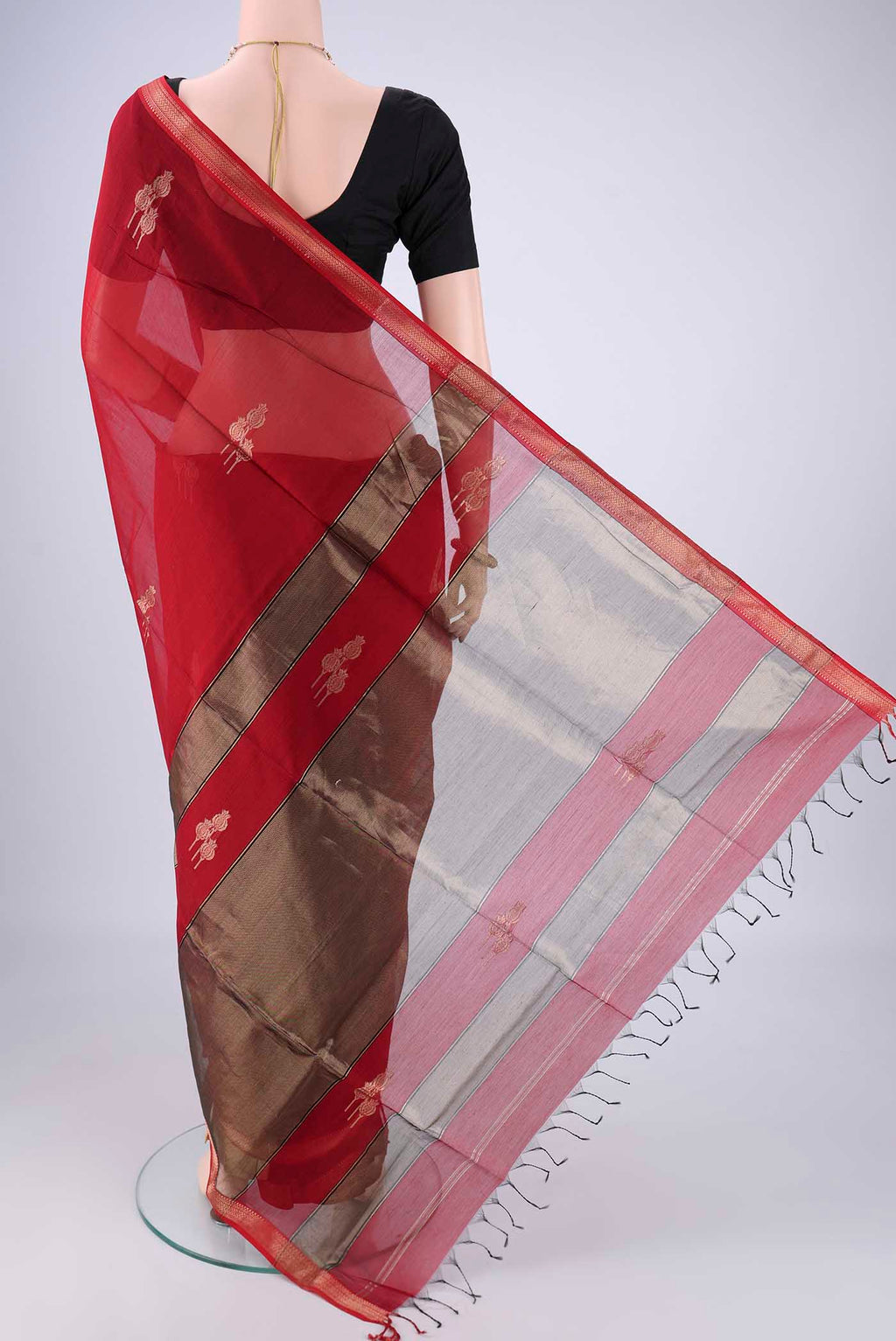 Flat view of Maroon Maheshwari Silk Cotton Saree with Zari Butta on the body and Zari Border. 