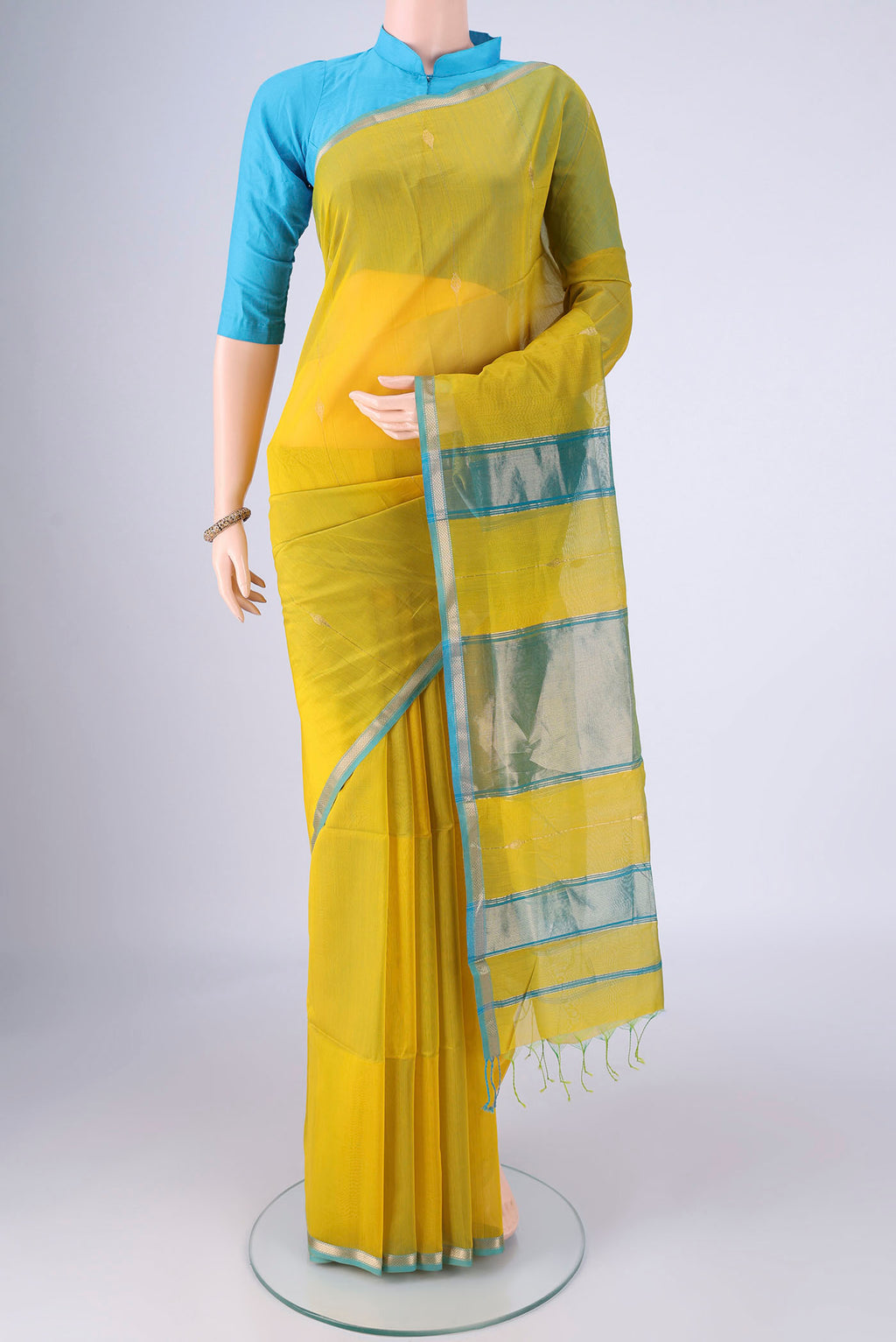 Yellow Maheshwari Silk Cotton Saree with Zari Butta on the body and Zari Border.  displayed on a mannequin