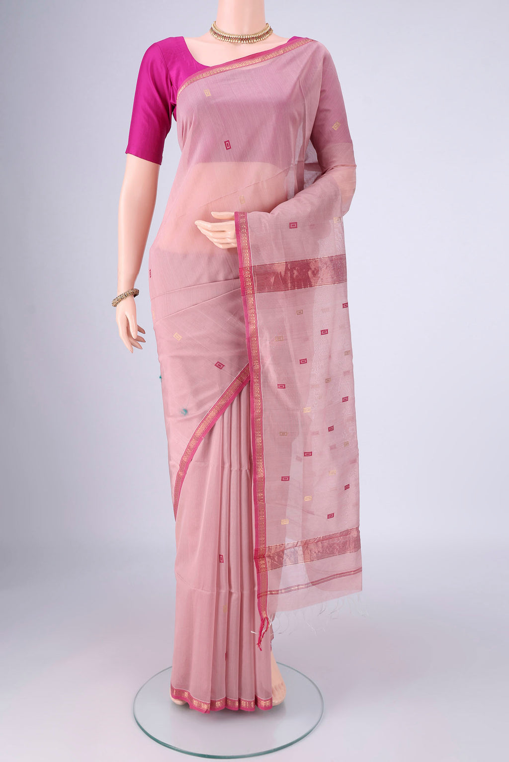Rose pink Maheshwari Silk Cotton Saree with Zari And Thread Butta on the body and Zari Border.  displayed on a mannequin
